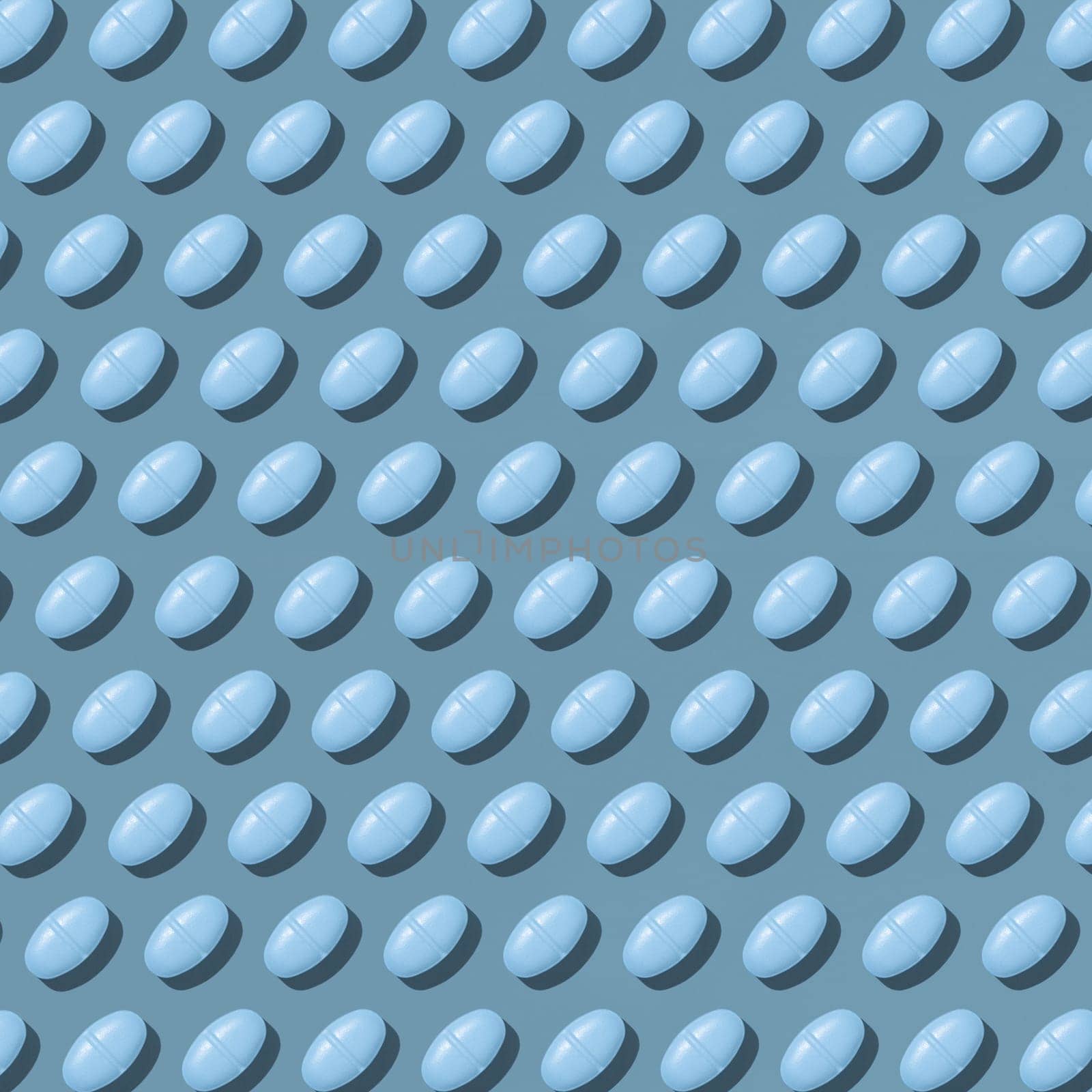Blue medical pills on blue top view, hard light, creative pattern. Medicinal treatment for desease, pharmaceutical products for healthcare. Taking dietary supplements and vitamins
