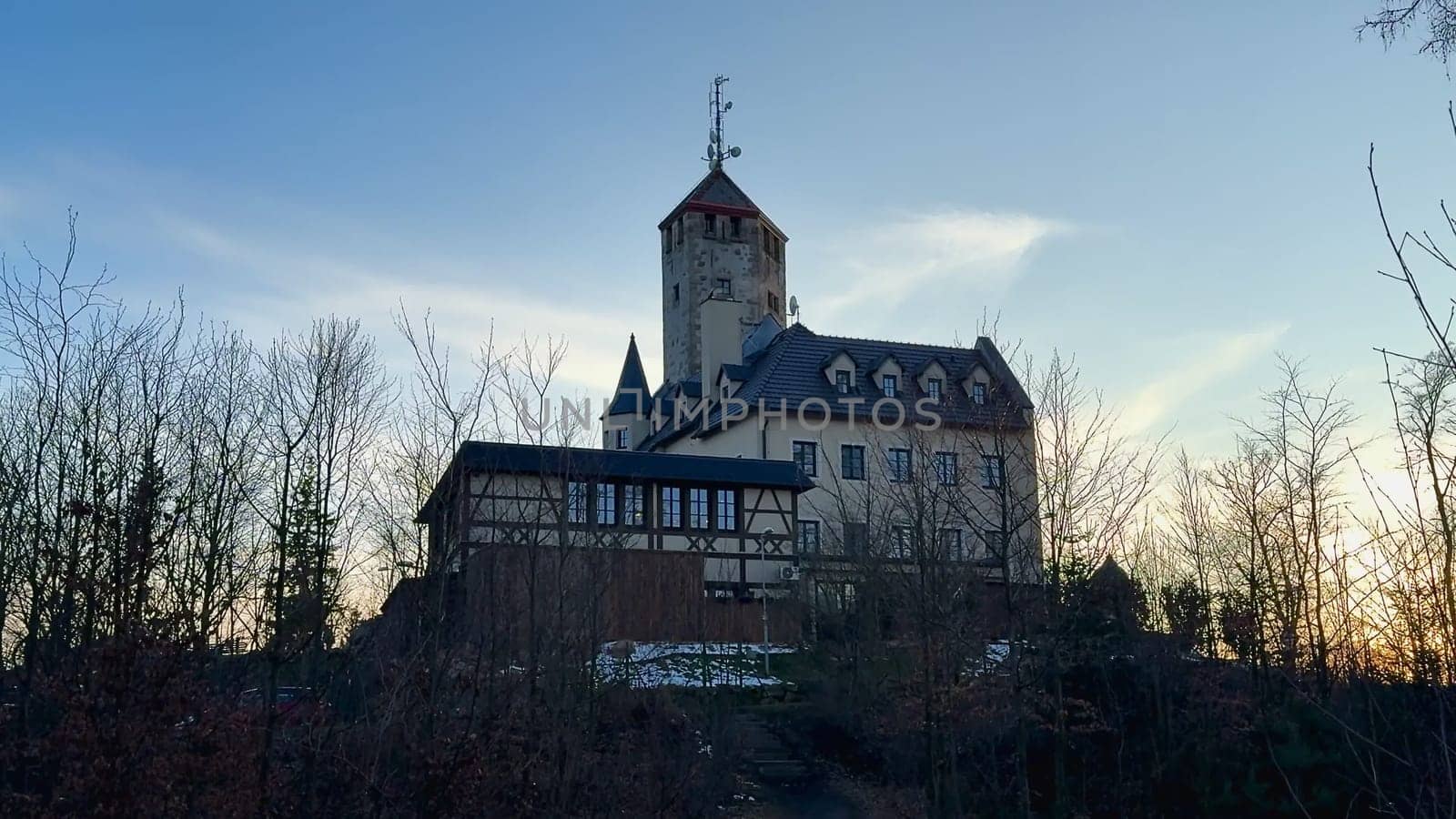 A stunning and enchanting castle beautifully capturing the breathtaking beauty of twilight amid lush greenery