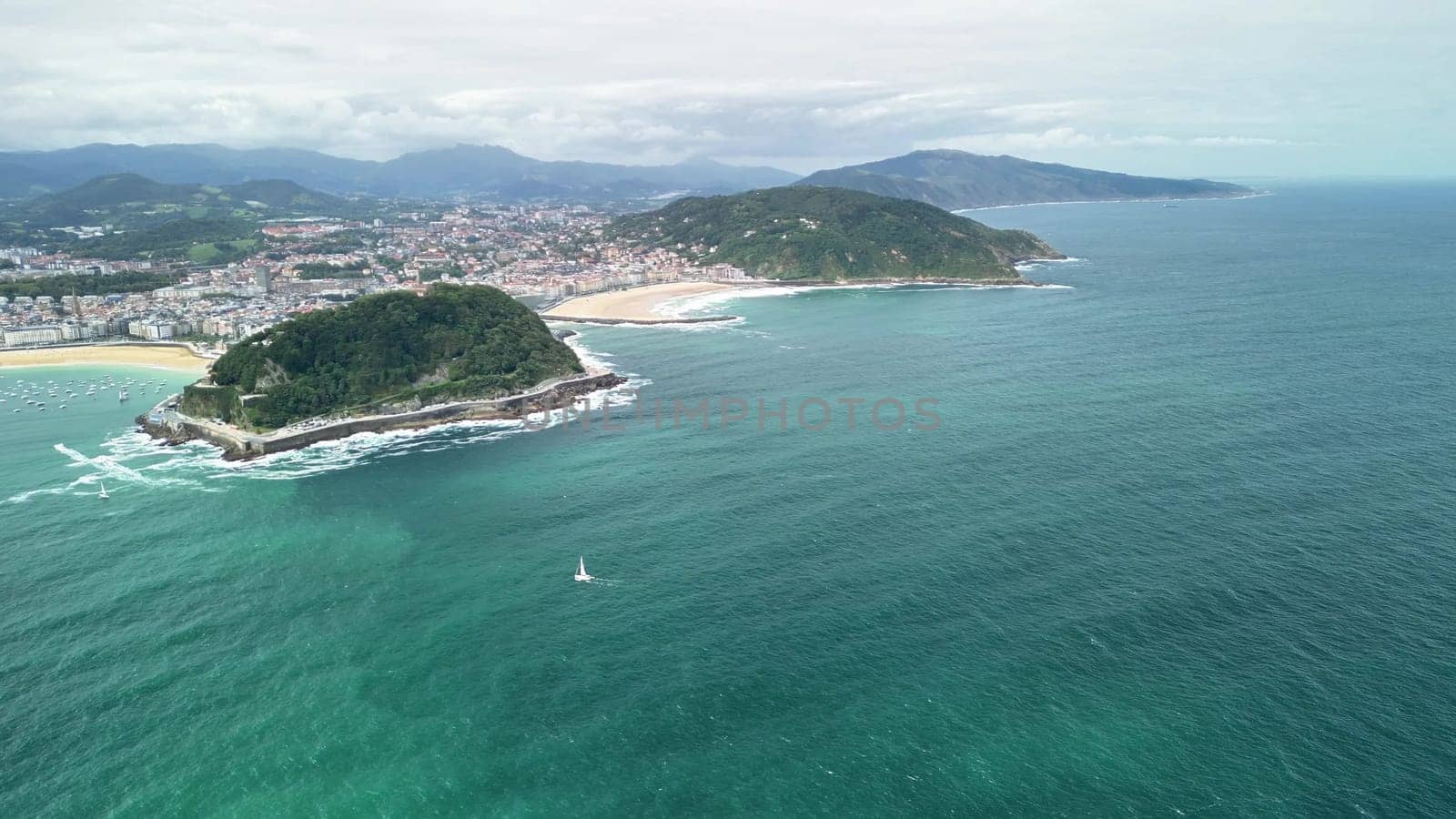Breathtaking aerial view showcasing an island, city, and ocean, perfect for travel and nature themes.