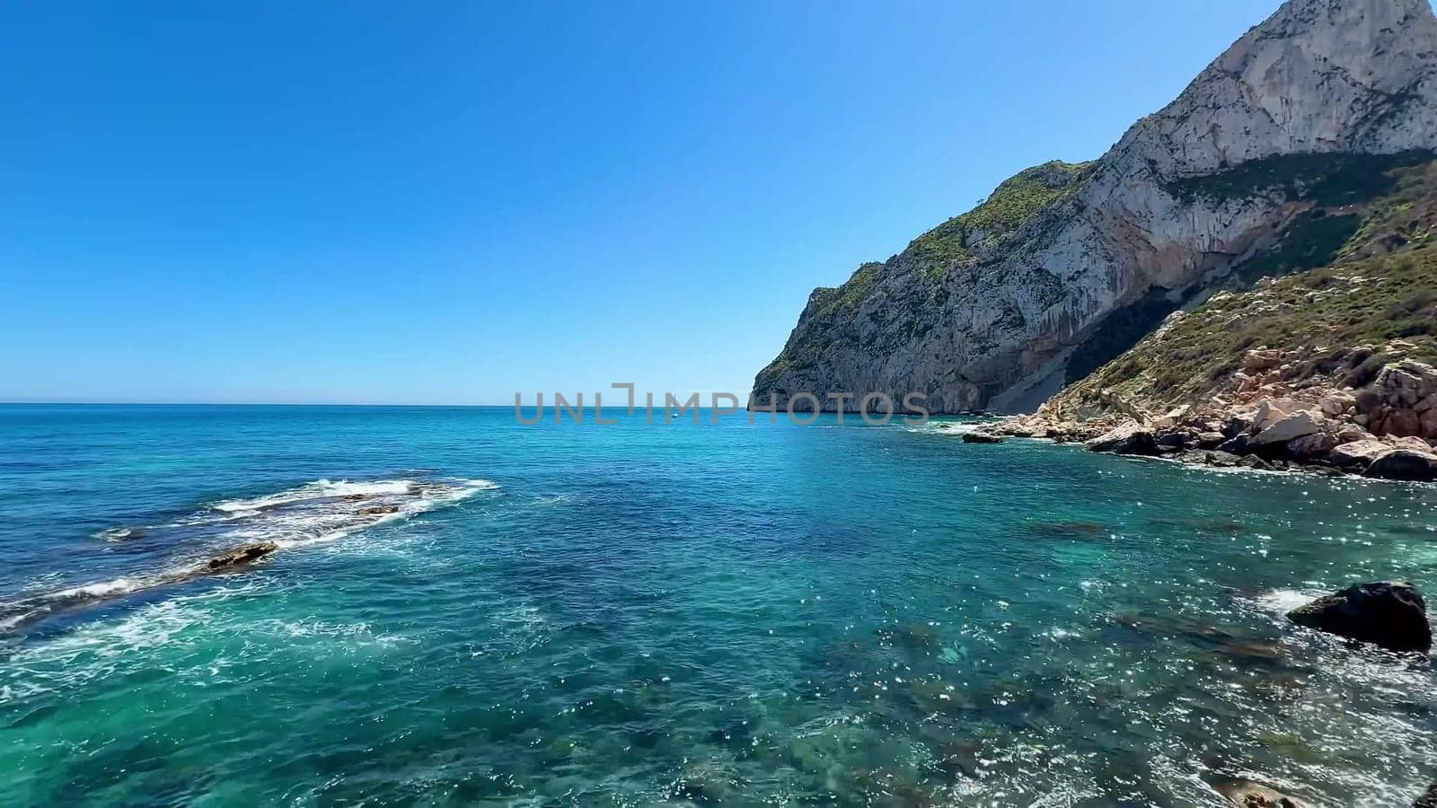 A stunning and breathtaking seascape depicting beautiful turquoise waters along with dramatic high cliffs