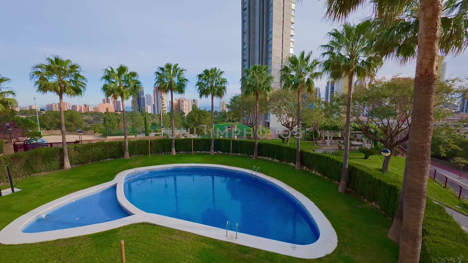 Imagine enjoying a stunning pool view surrounded by tall buildings and lush palm trees in an urban environment