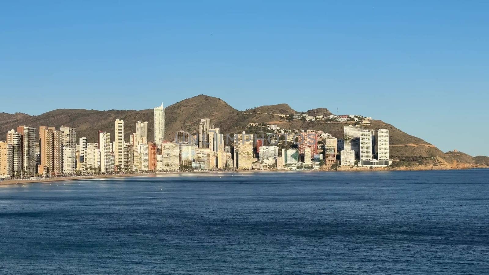 A breathtaking and stunning coastal panorama showcases towering highrises set against a tranquil ocean backdrop