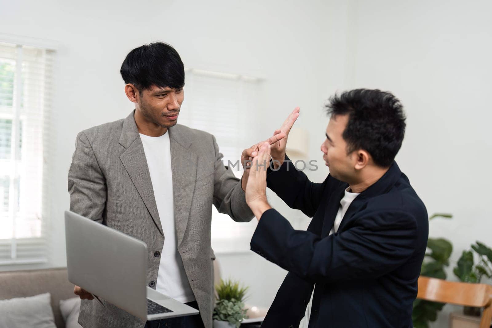 In a modern office environment, two business professionals are discussing strategies, demonstrating enthusiasm and collaboration. Their body language reflects a positive exchange of ideas.