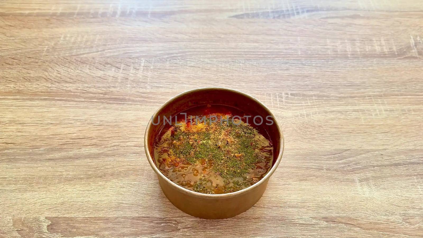 A delicious and flavorful bowl of soup generously topped with fresh herbs, perfect for any meal or occasion