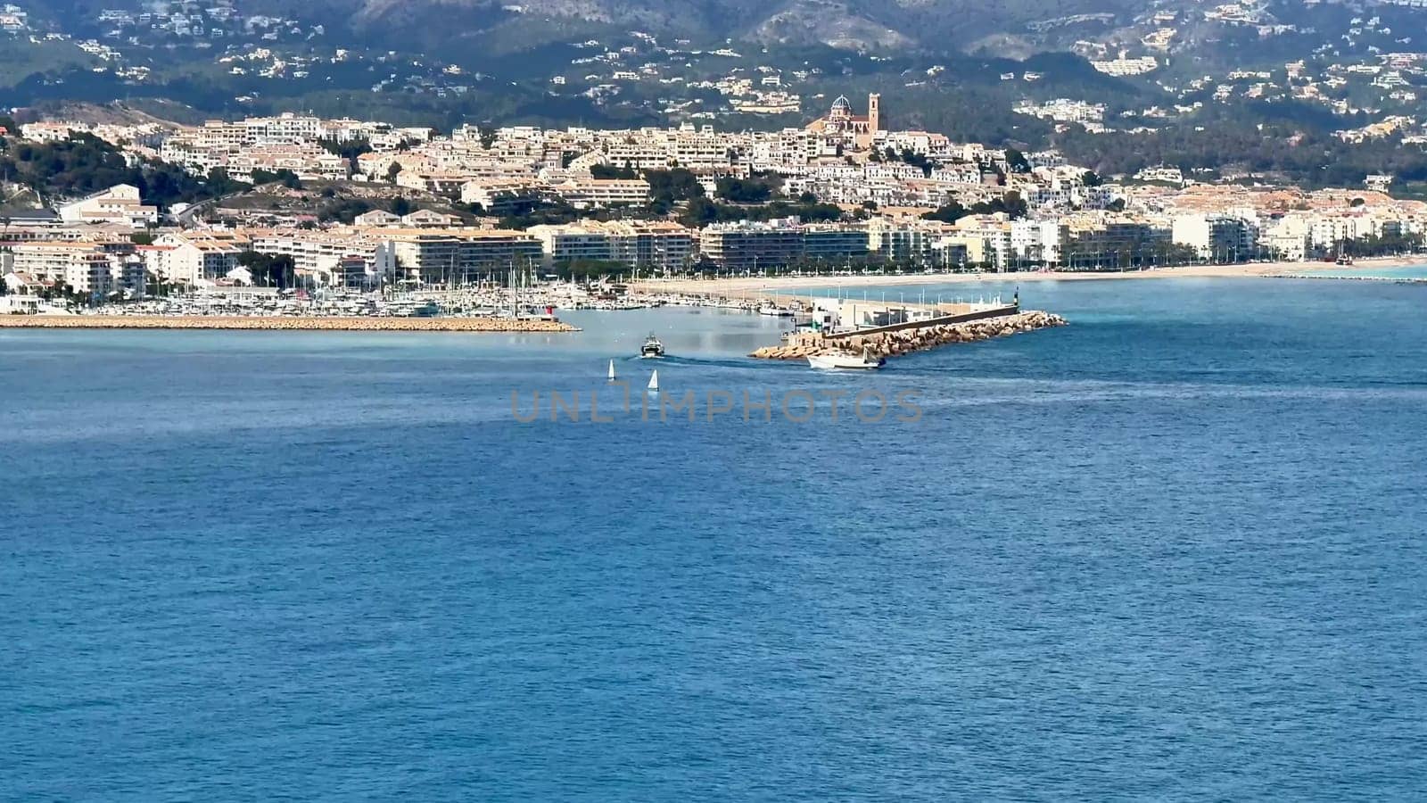 The coastal view showcases tranquil blue waters alongside vibrant and picturesque shoreline scenery