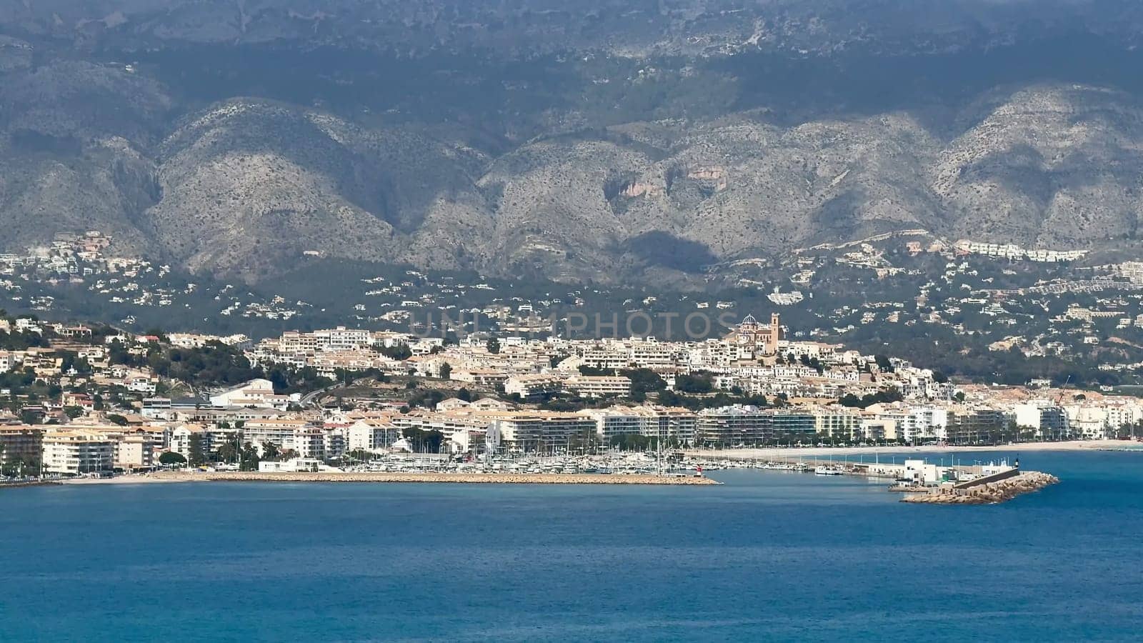 A stunning and breathtaking seaside landscape showcases a vibrant beach along with a picturesque mountainous backdrop