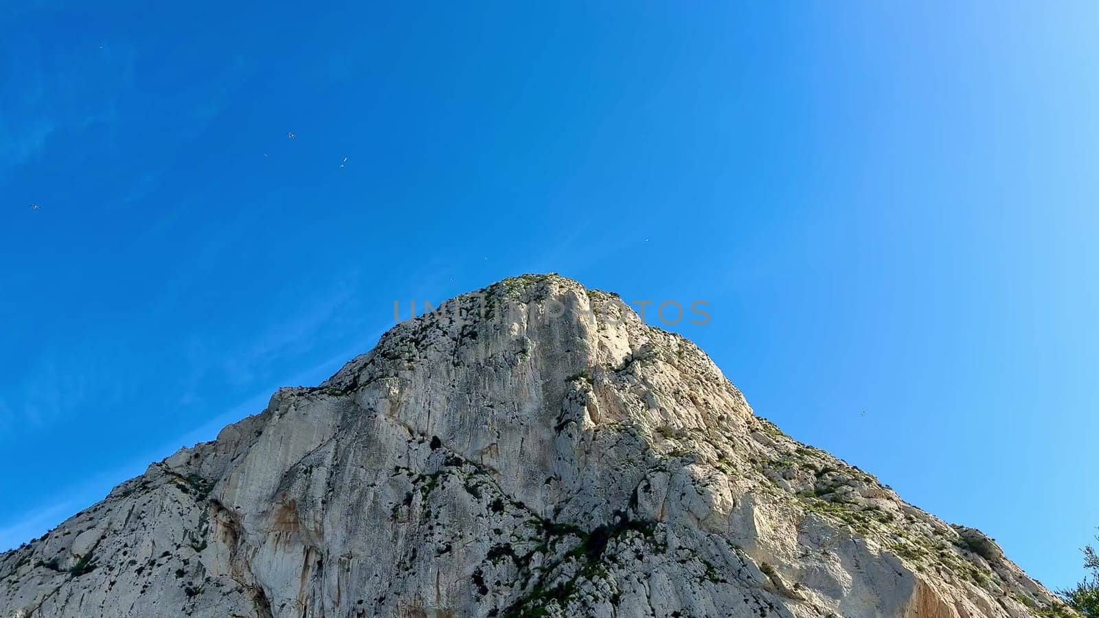 A majestic mountain peak rises against a clear blue sky, showcasing natures breathtaking beauty and splendor