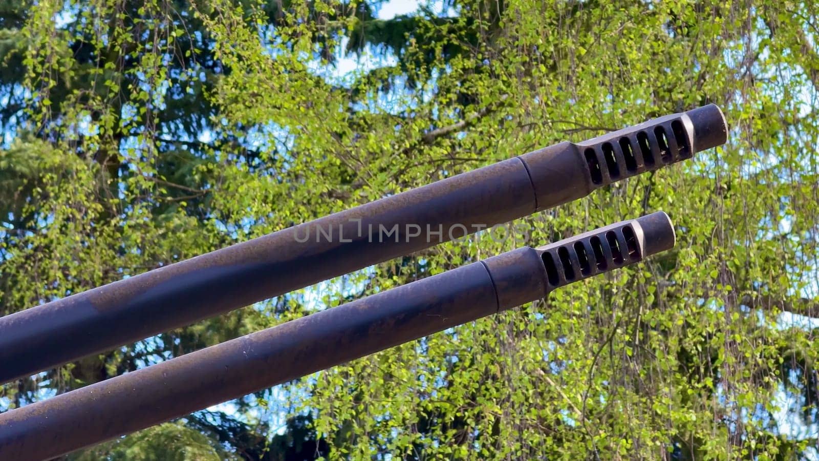 Two sleek black tube barrels contrast vividly against a vibrant green background, enhancing their appeal