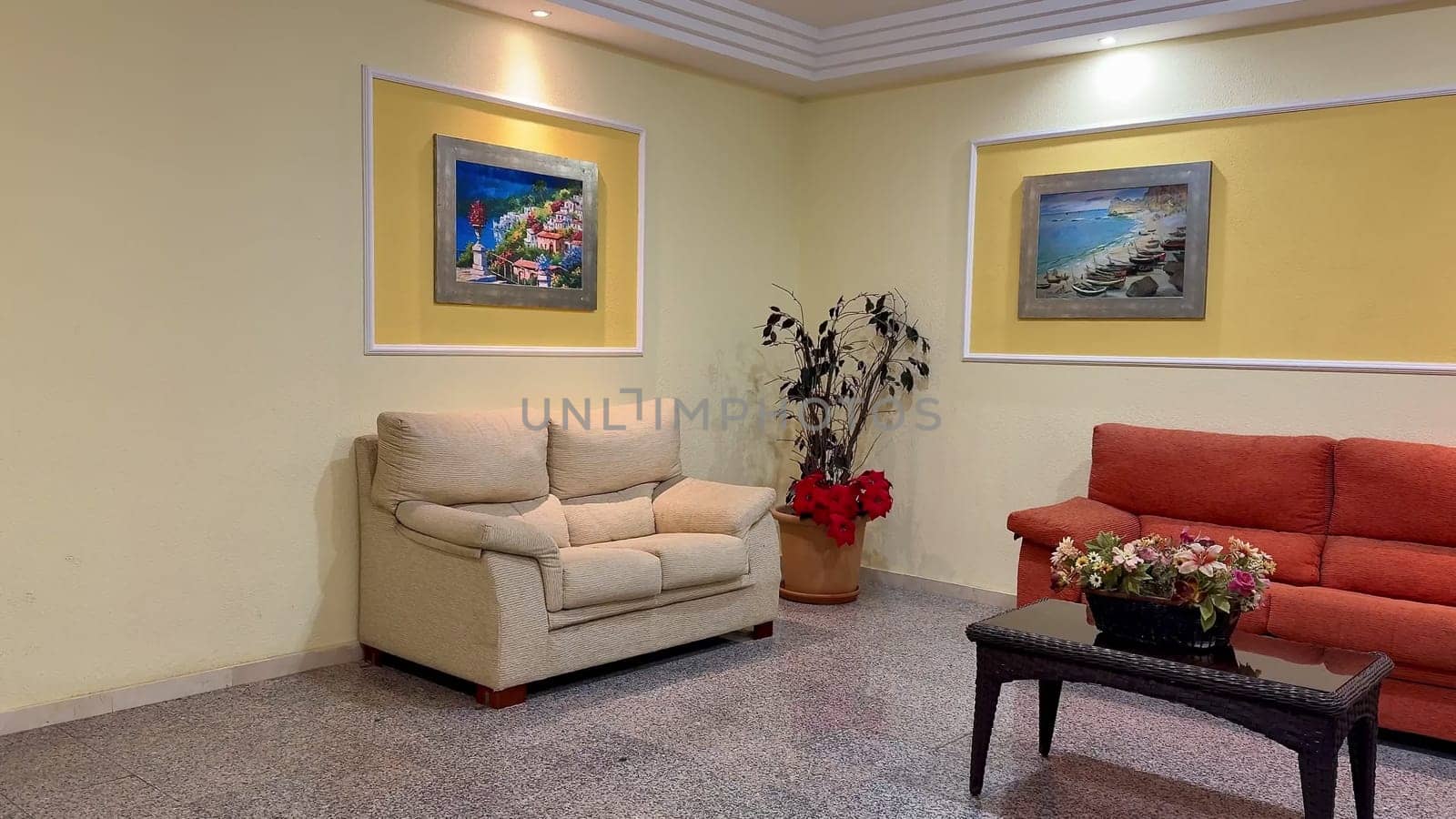 A contemporary and modern living room that features comfortable seating along with vibrant and striking artwork
