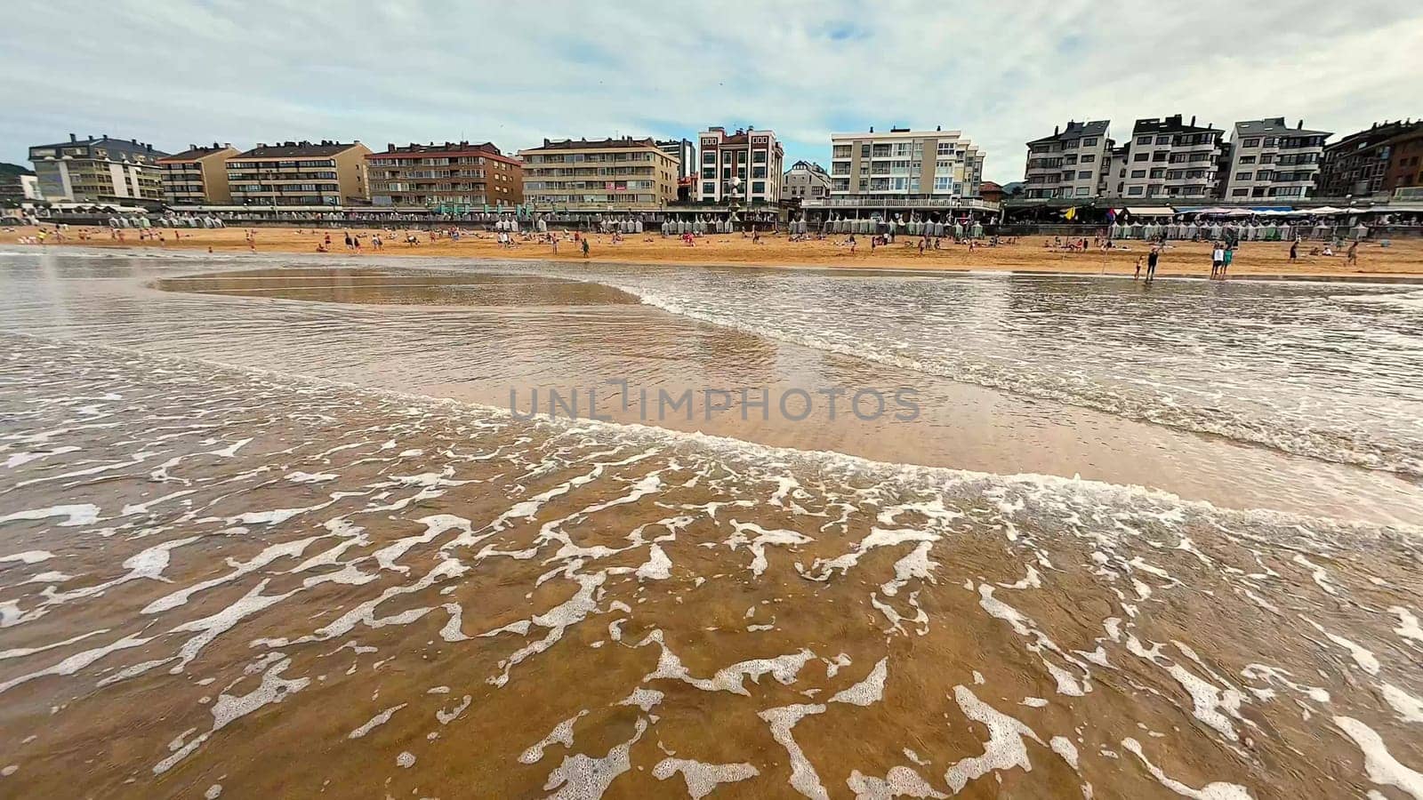 A beautifully tranquil beach scene showcasing gentle, rolling waves alongside a picturesque coastal view and landscape