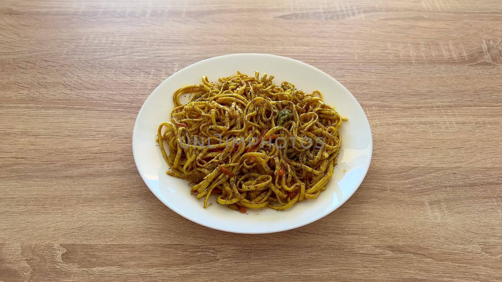 A delightful plate of wellflavored stirfried noodles, featuring a variety of vibrant spices and fresh ingredients