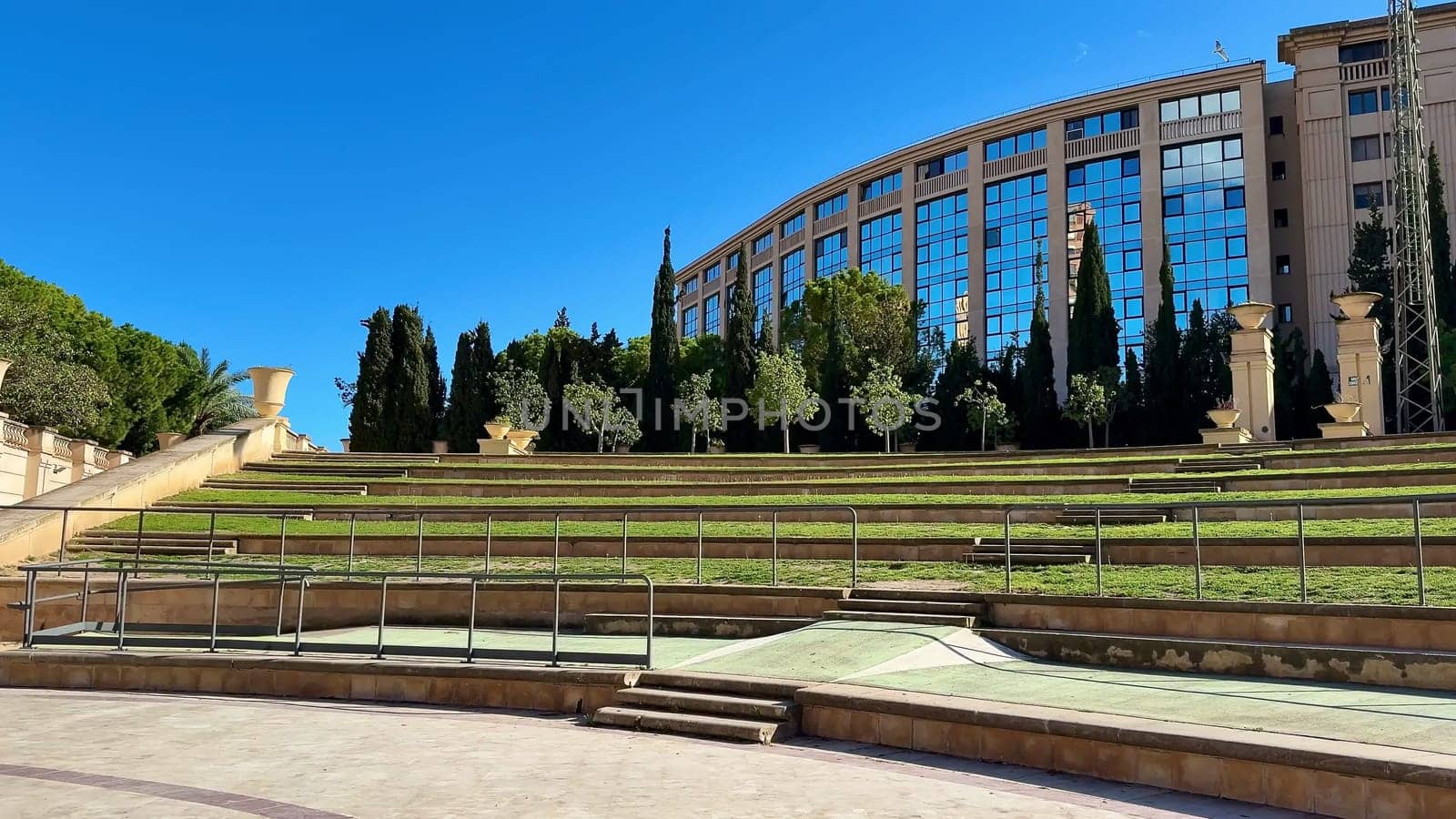 This is a beautifully picturesque view of a modern green space, which is surrounded by elegant architecture