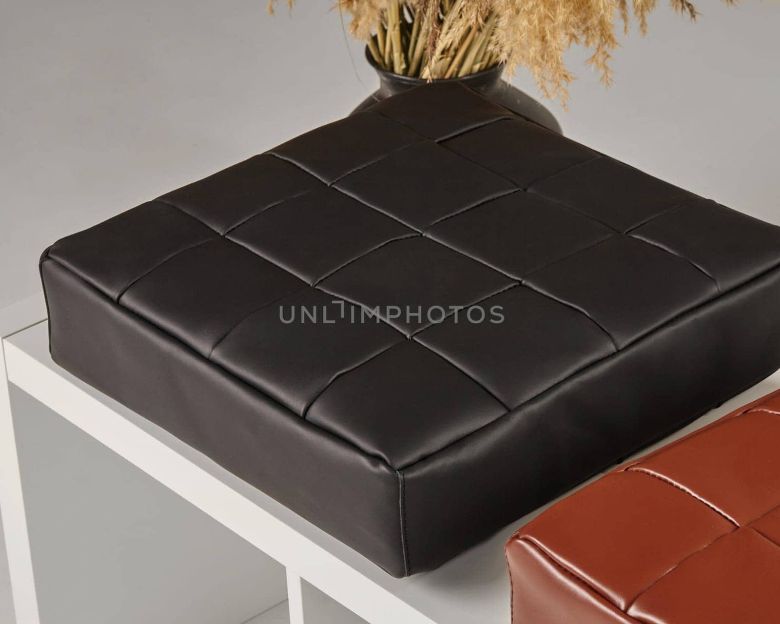Stylish black leather seat cushion adds a touch of elegance to a contemporary interior design setting