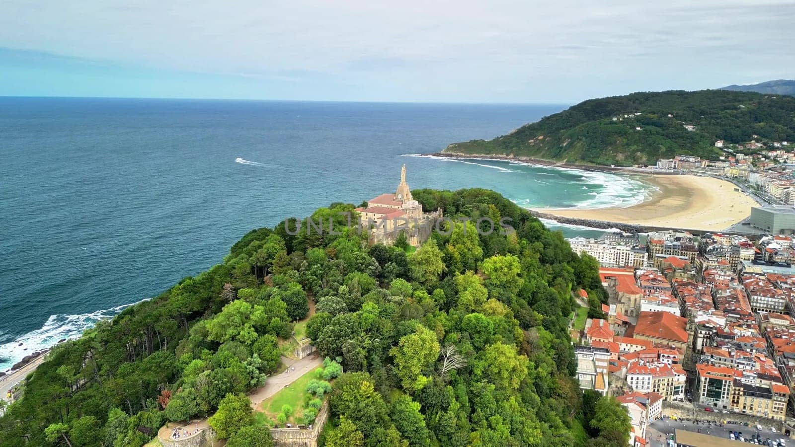 This stunning aerial scene showcases the lush greenery along with a gorgeous beach at the beautiful coastline