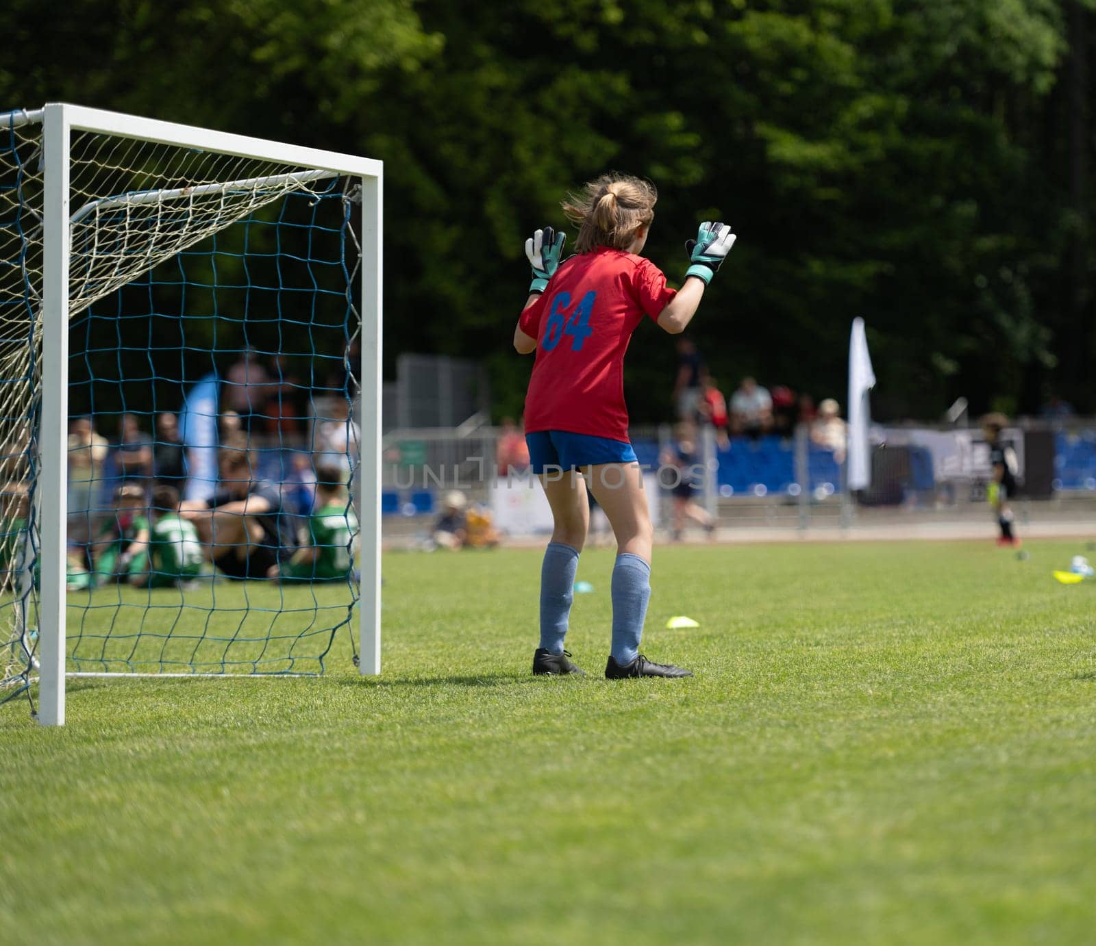 Girl Goalkeeper Stands At Goalposts During Children'S Football Match