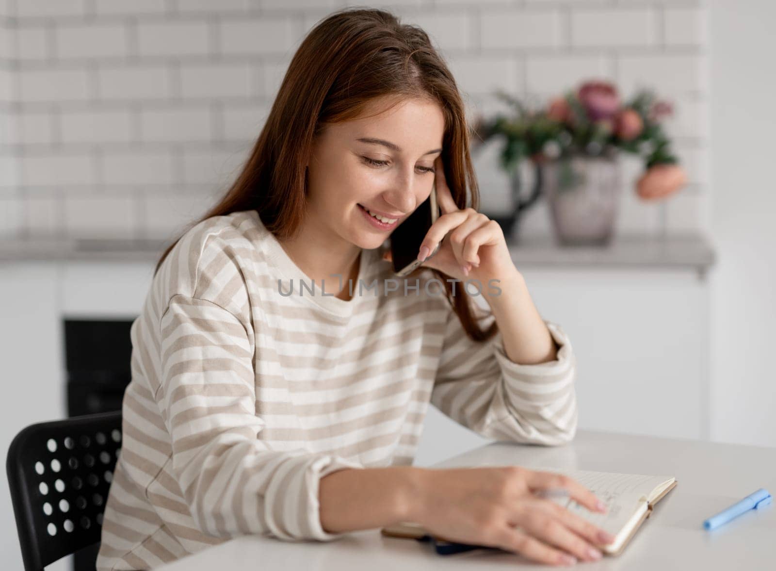 Girl Smiling While Talking On The Phone At Home