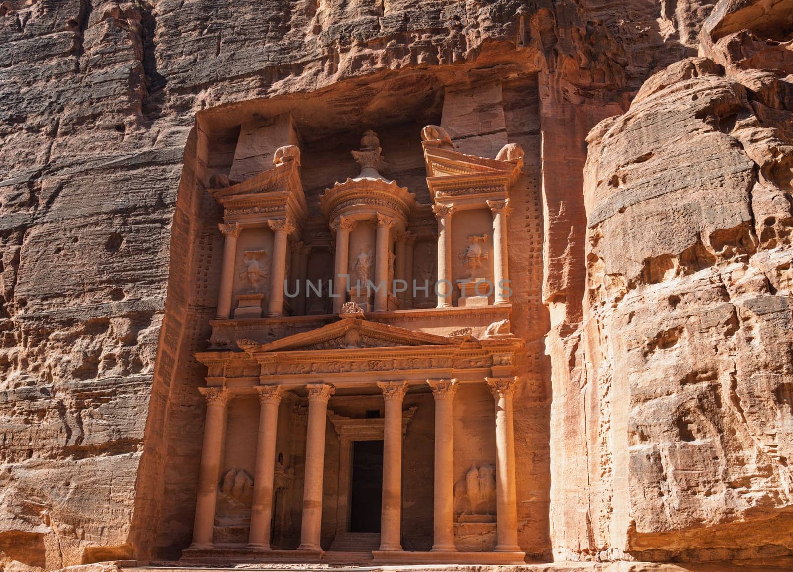 View of the carved facade of the Treasury building or Al-Khazneh in the ancient city of Petra