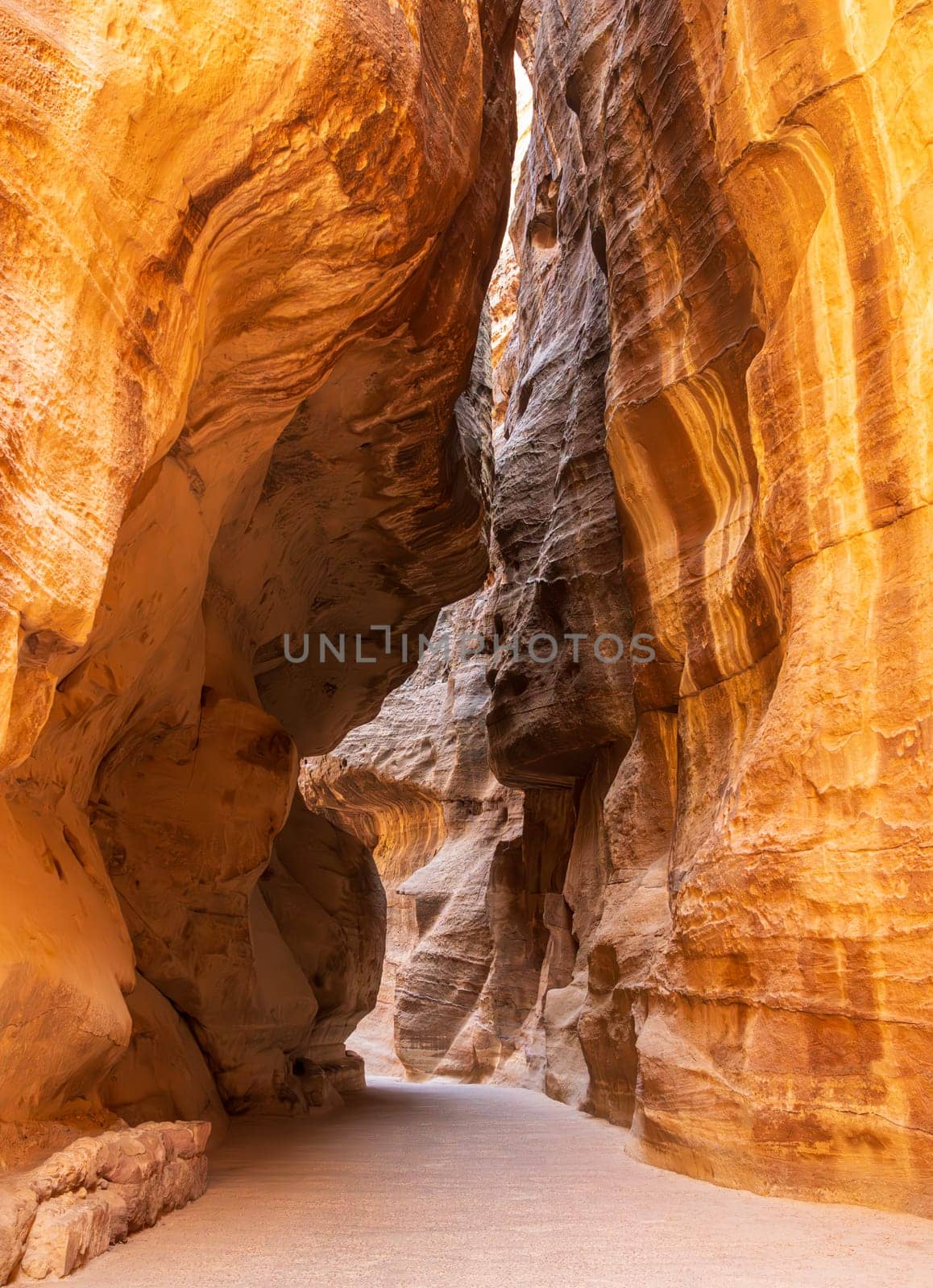 Water carved canyon walls of the narrow gorge of the Siq entering Petra in Jordan