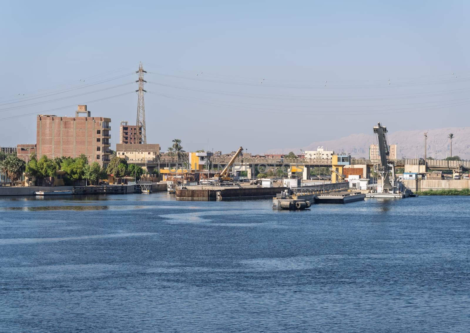 Approaching the new Esna dam and lock on Nile River with gates open for entry