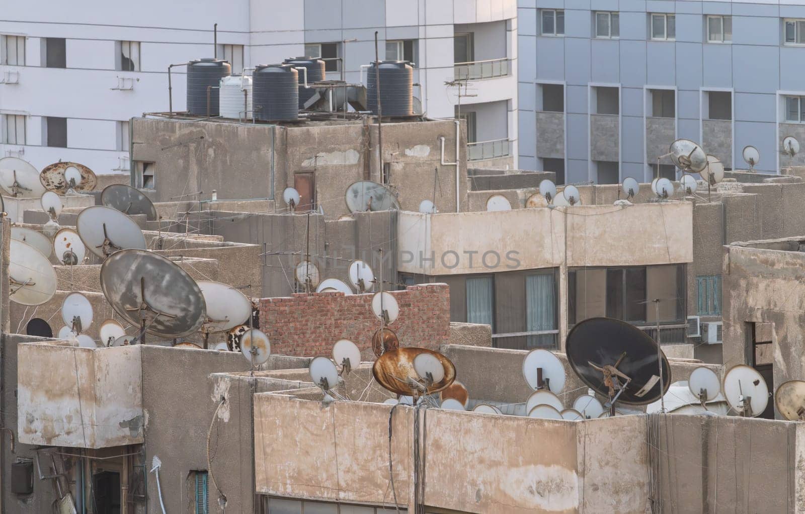 Many satellite dishes crowd the rooftops of apartment buildings in Cairo near the airport
