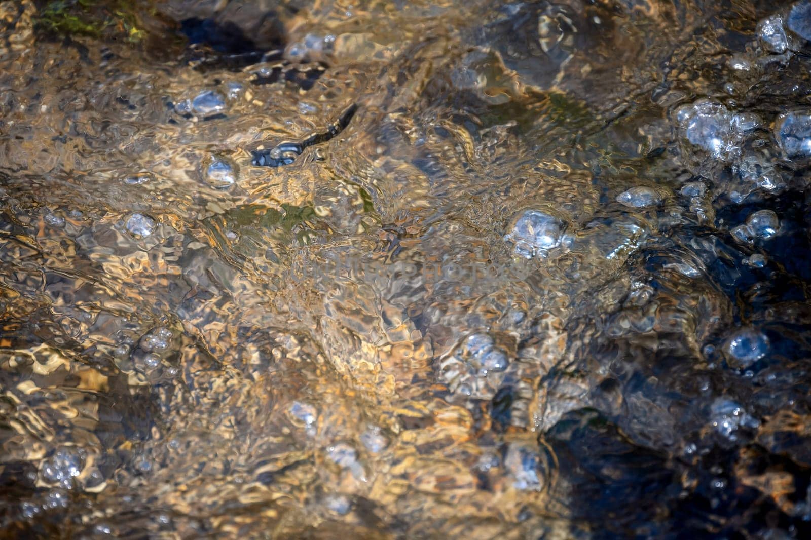Abstract background of flowing water with bubbles