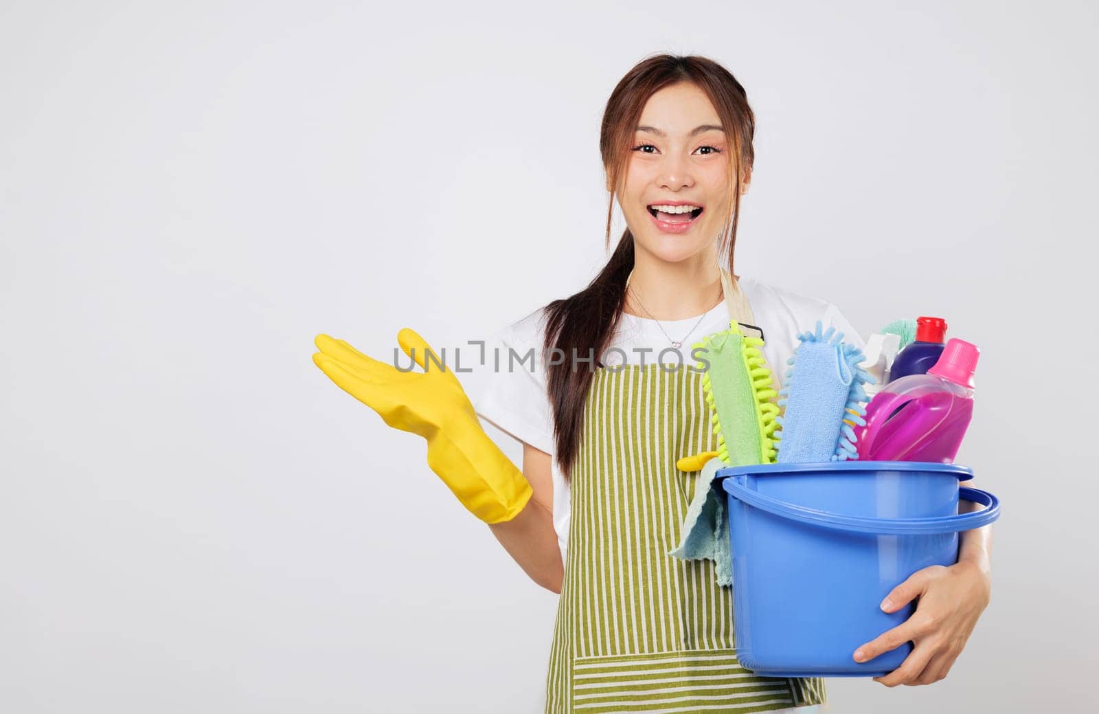 Cleaning professional supplies with apron and bucket, showing open palm. Promote your cleaning product or housework solution with confidence. isolated white background with empty space for your text