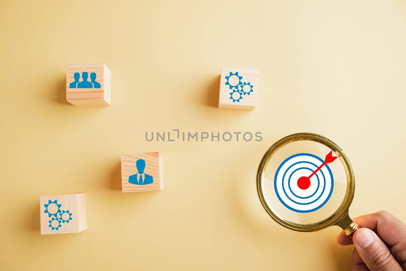 Focus through magnifying glass on te target icon, which embodies start-up, creative ideas, and innovation. signifies motivation, planning, development, leadership for customer targeting in business.