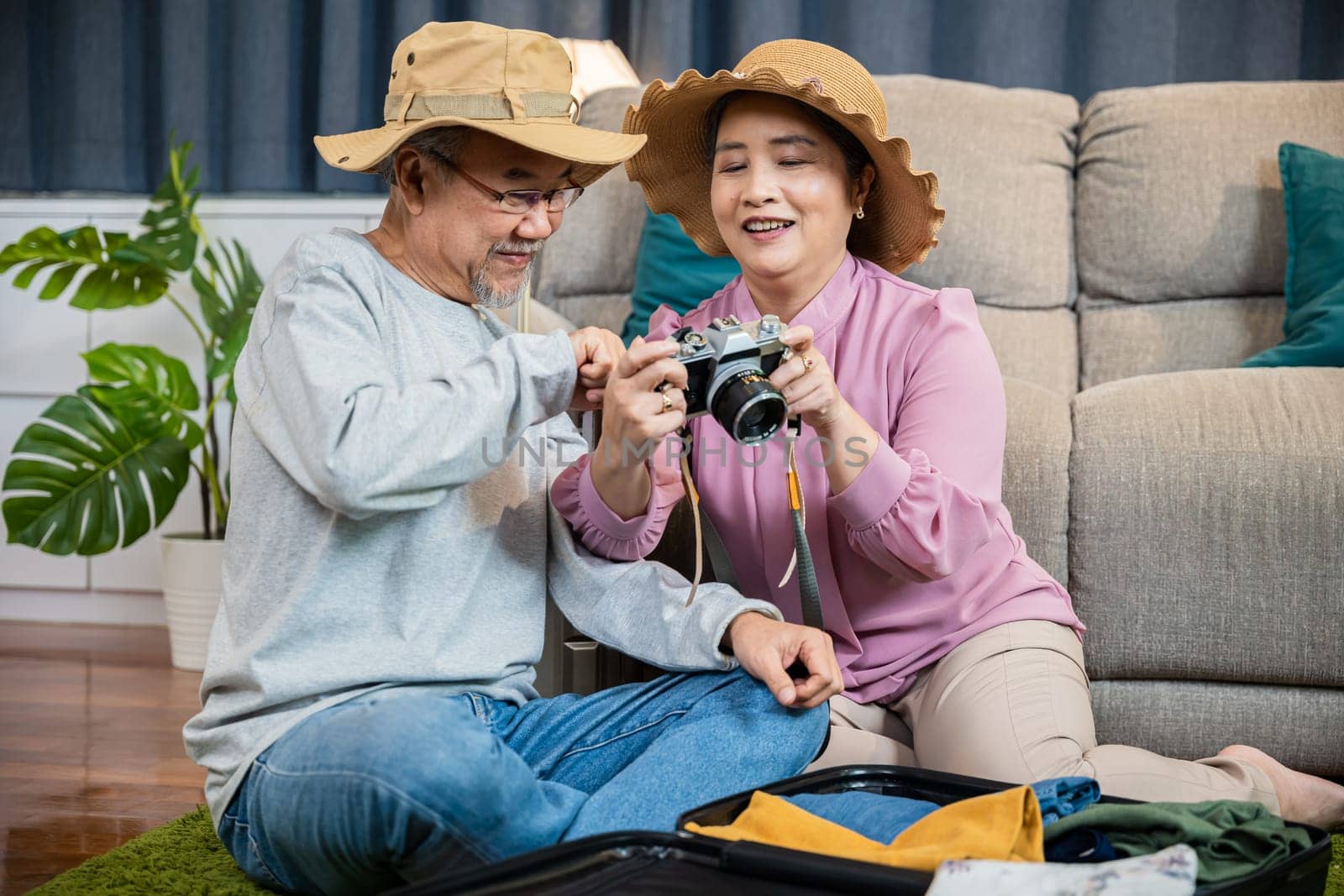 Travel and tourism. Happy mature retired couple photography weekend holiday, Asian couple old senior marry retired couple smiling taking photo by camera during luggage suitcase arranging for travel