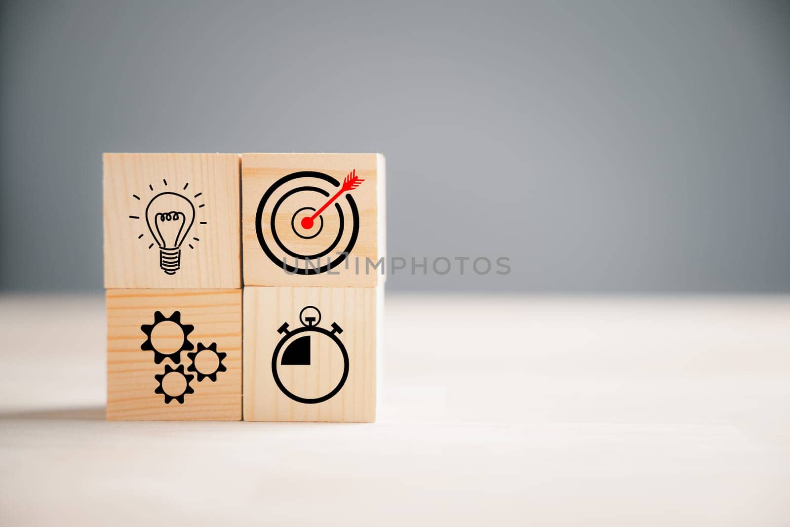Wooden block step with Action Plan, Goal, and Target icons. Success and business target concept. Company strategy and project management on a table. Marketing background.