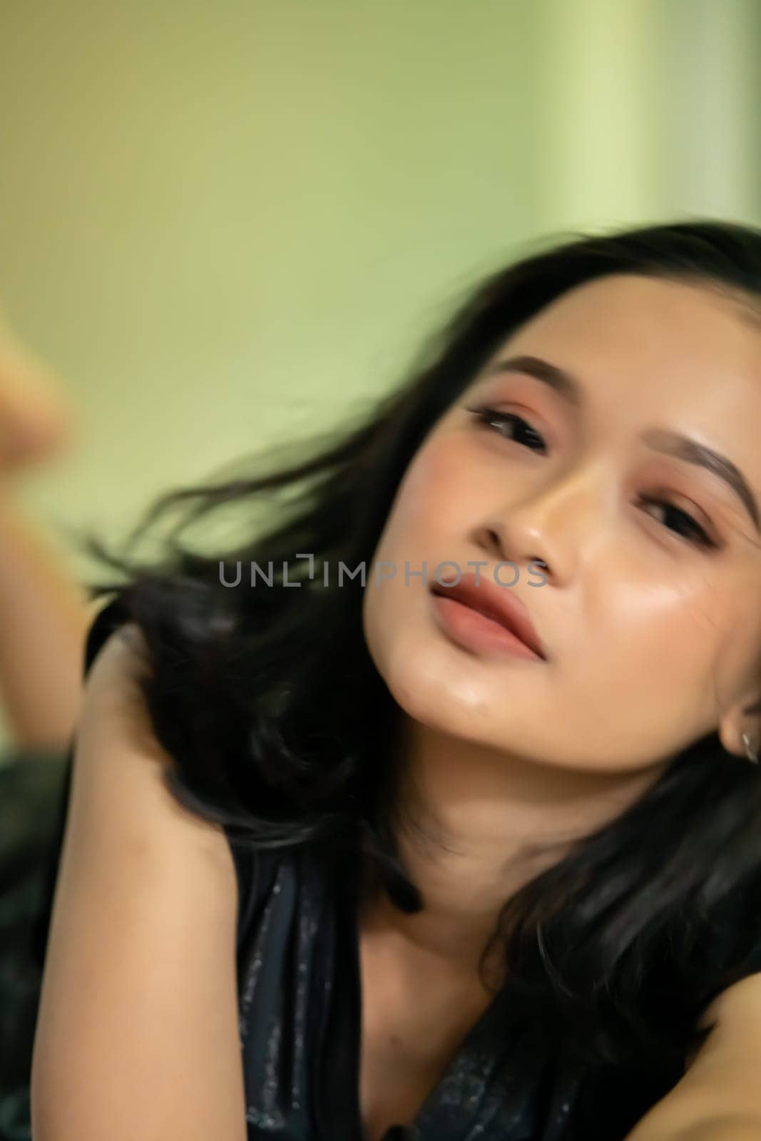 Hangover faces of Indonesian women after drunk in the bedroom lonely