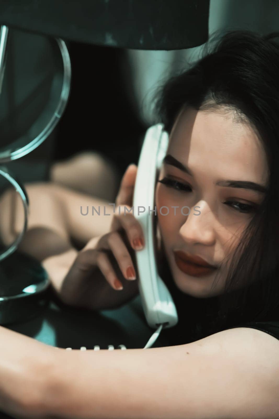 A Woman holding a phone and put it in her ear while calling the police for a crime