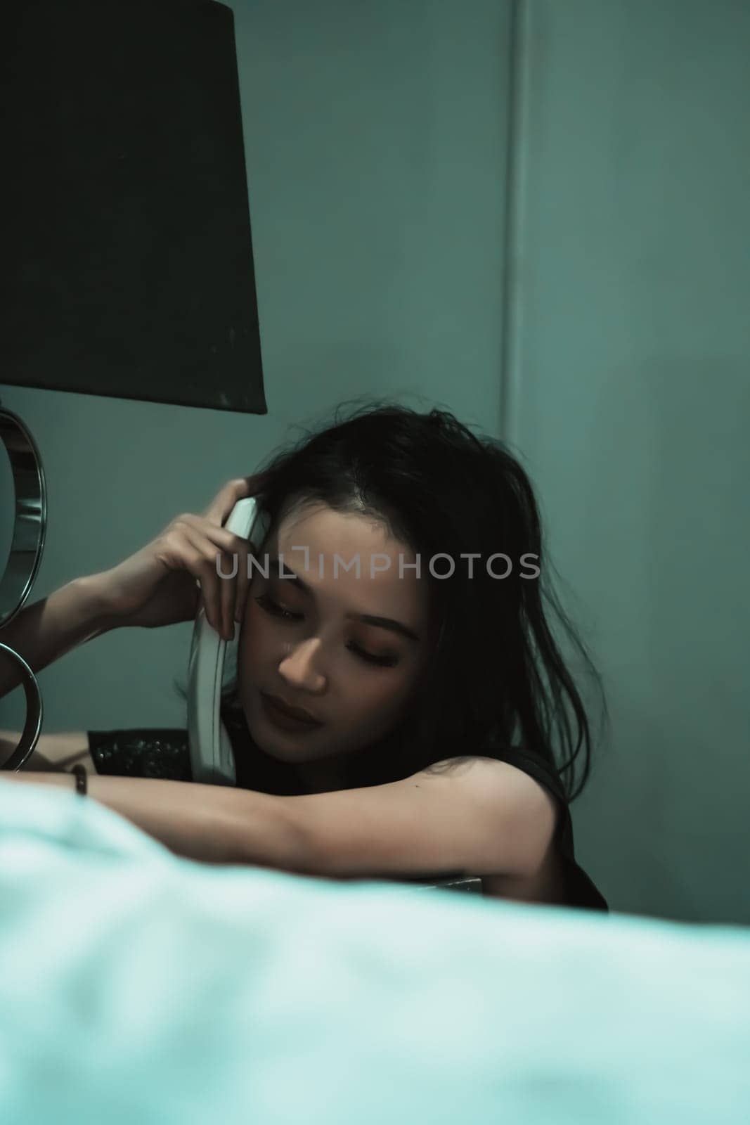Young Woman on Phone at night in bedroom