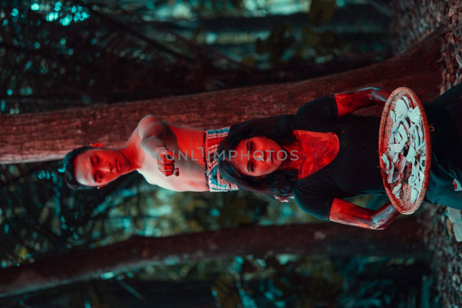 a couple of serial killers have bodies covered in blood and are performing a satanic ritual in the middle of a forest before sunset