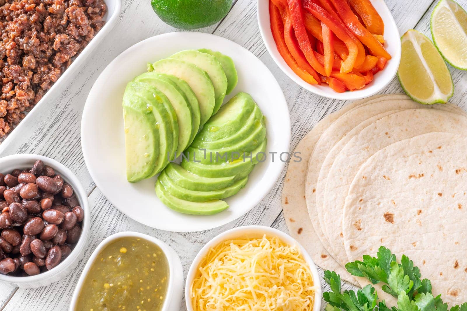 Tortillas surrounded by vibrant toppings and fillings, ready to assemble flavorful tacos