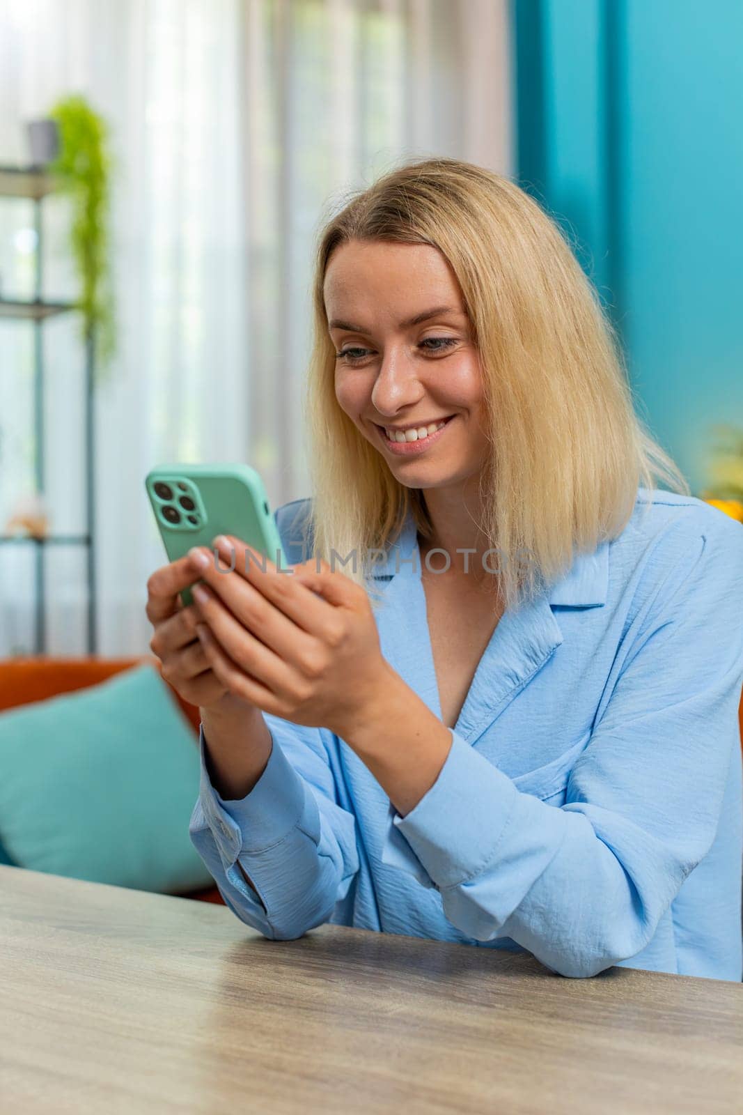 Young businesswoman working smartphone online remote distance job education sitting at table from home office. Girl woman freelancer study, e-learning, texting share messages content on social media