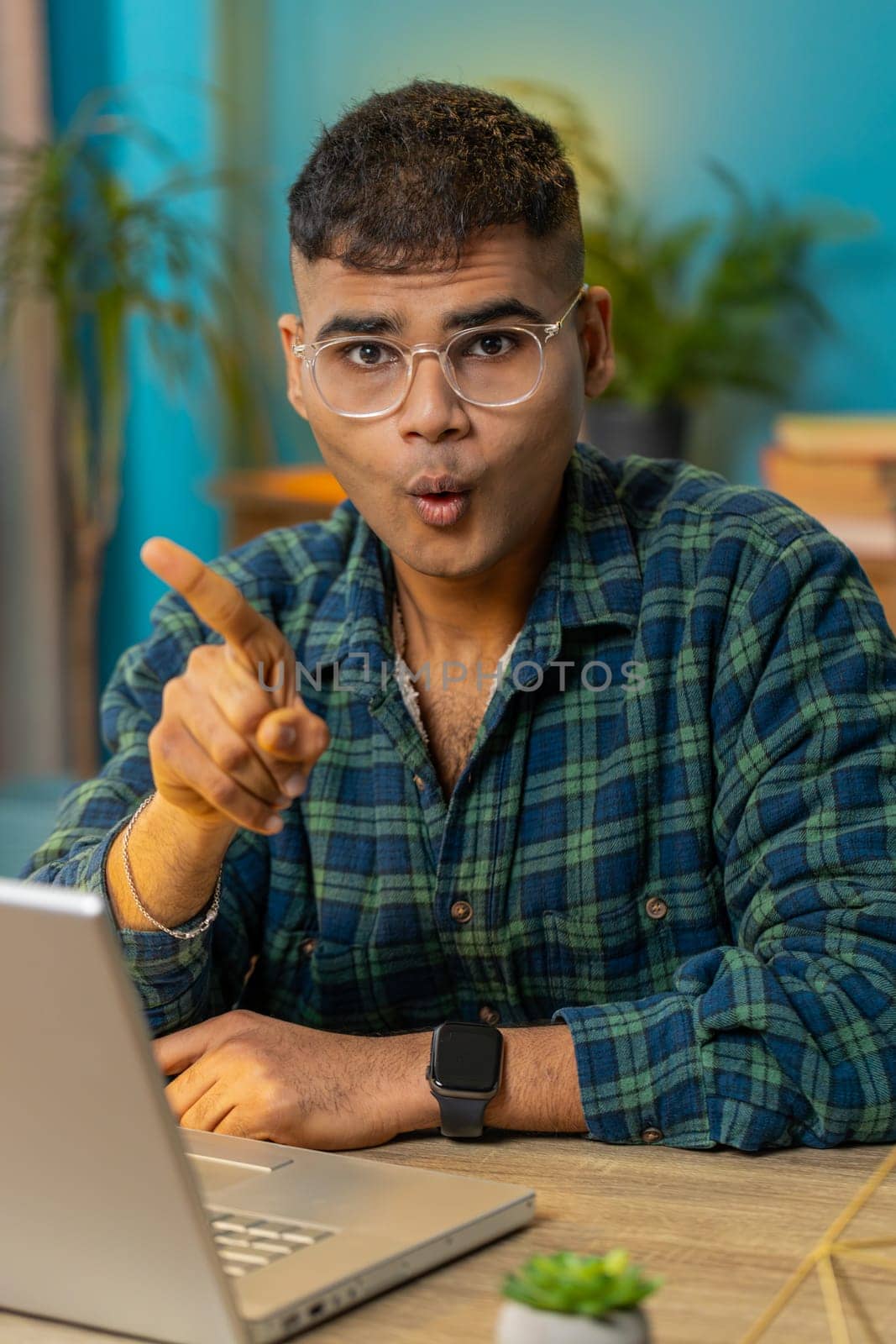 Displeased upset Indian man reacting to unpleasant awful idea, dissatisfied with bad quality, wave hand, shake finger No, dismiss idea, don't like proposal. Hispanic guy at home office table. Vertical