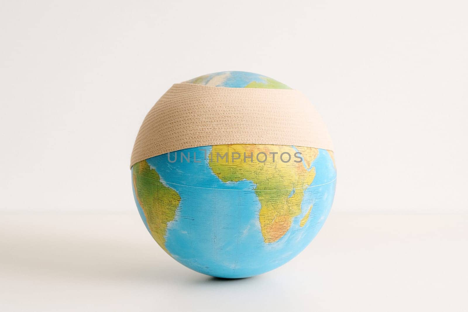 AI generated realistic globe with bandage wrapped around it symbolizing environmental damage and healing concept white background climate change earth protection conservation metaphor