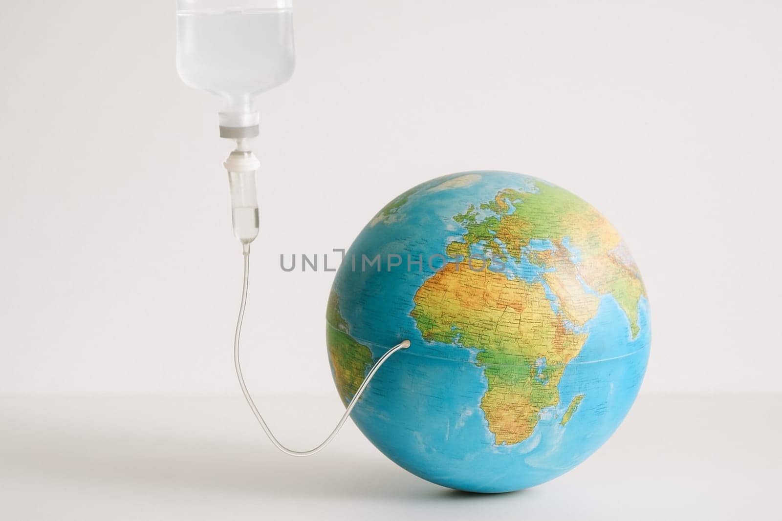 AI generated realistic globe with medical iv bag and tube symbolizing environmental care concept white background climate change earth protection healthcare metaphor
