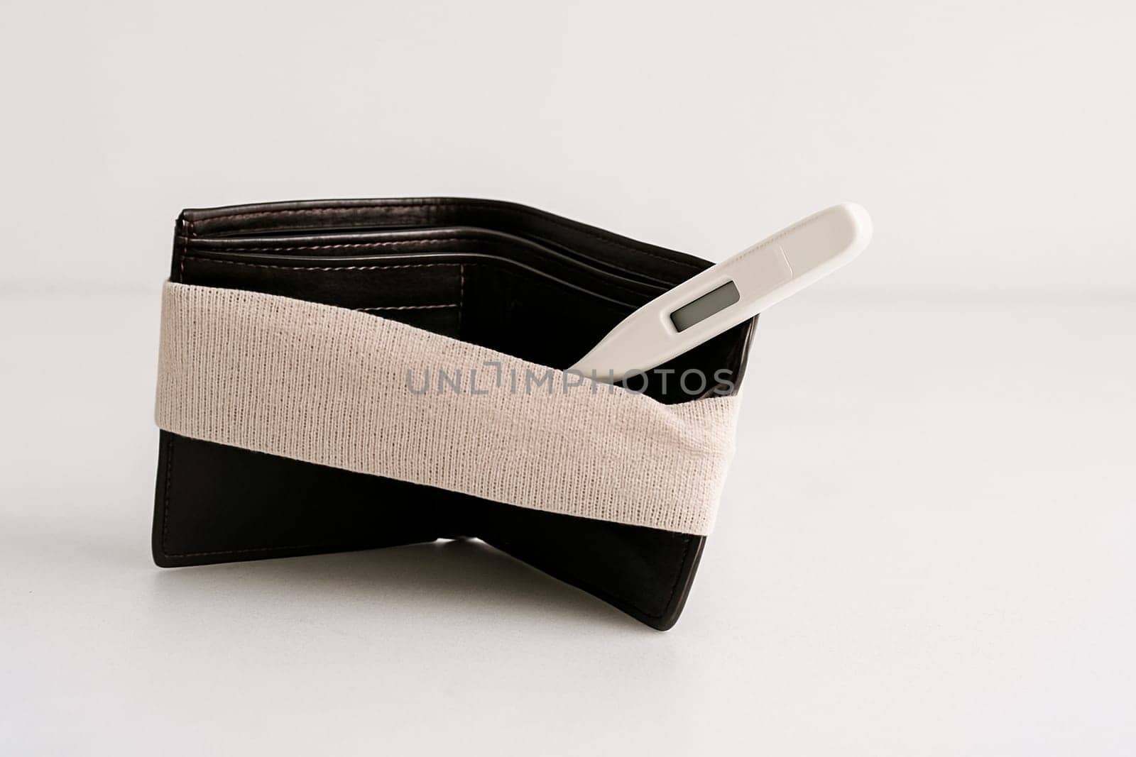 AI generated realistic empty men's wallet with bandage symbolizing financial injury and economic recovery concept white background money struggle healing metaphor