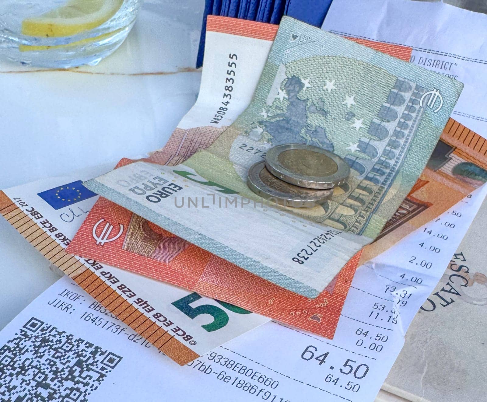 Tivat, Montenegro - April 25, 2025: a check with money on the table at Il Pescatore cafe,Marina Porto Montenegro