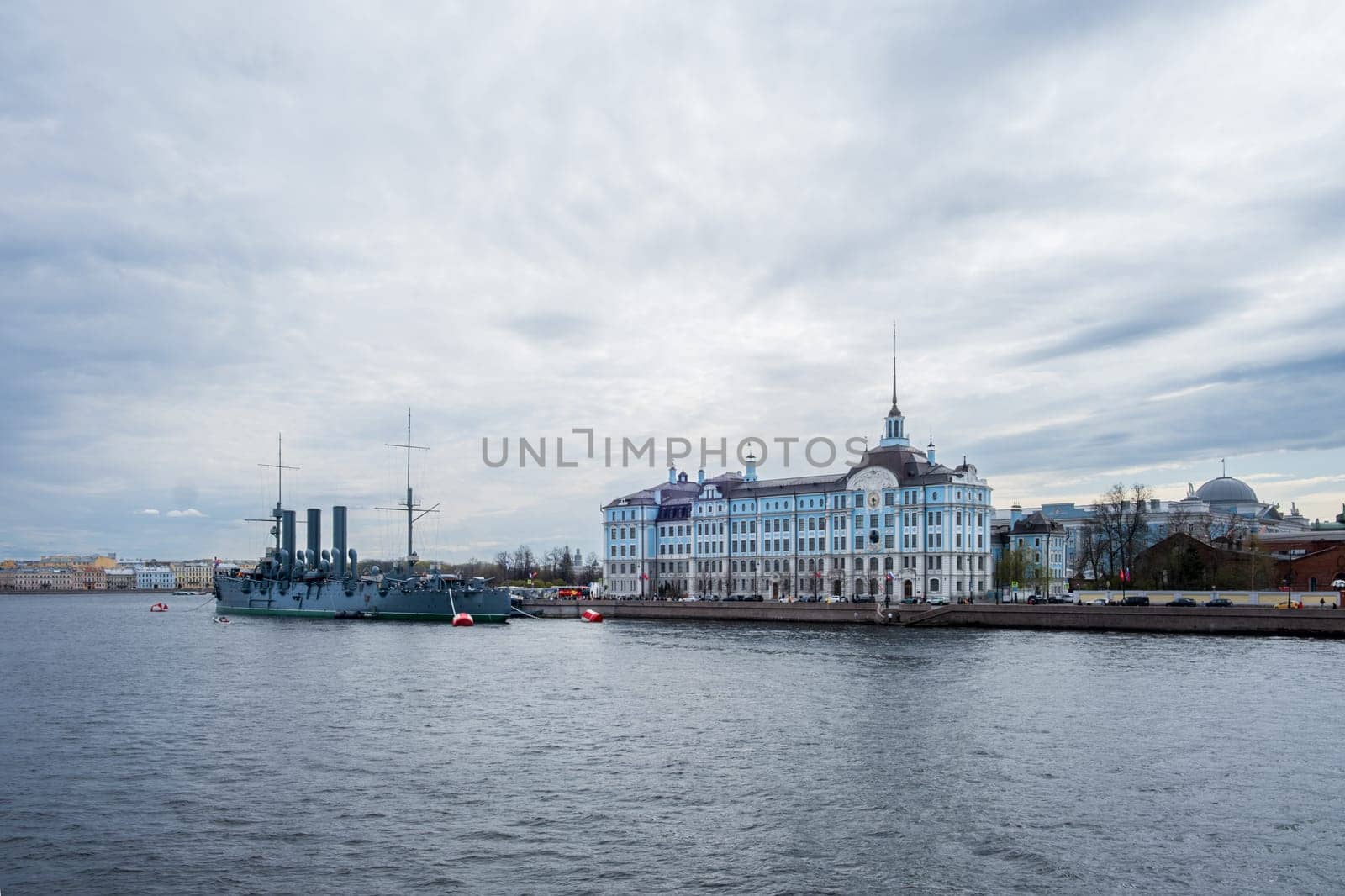 Saint Petersburg, Russia - 02.05.25. Cruiser Aurora moored near Nakhimov Naval school on the Neva River in St. Petersburg. Iconic landmarks represent Russia's maritime heritage and educational legacy.