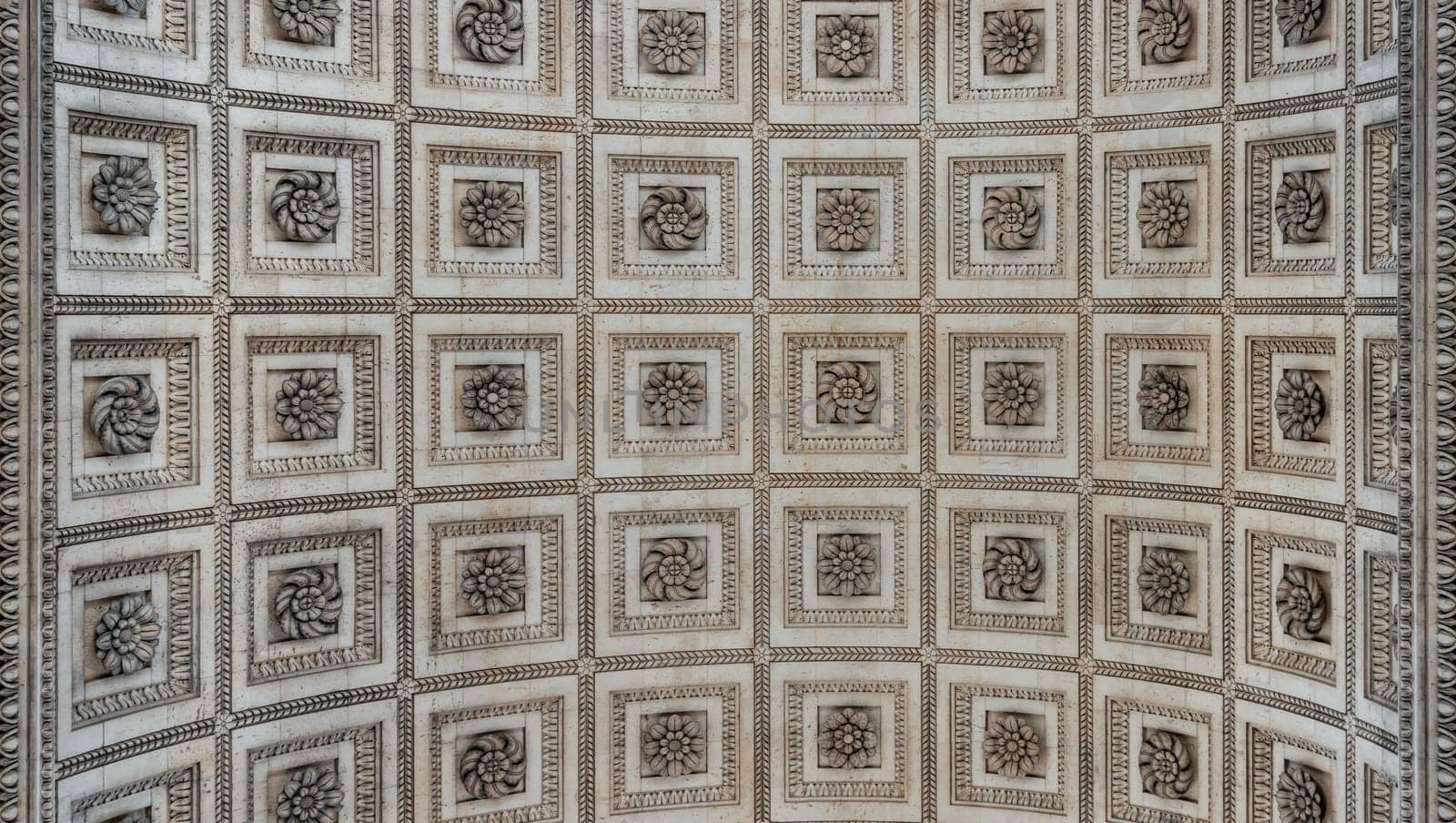 France, Paris - May 03, 2025 - Upward View to the ornate stone carvings ceiling centre inside of the famous Arc de Triomphe. Stunning details under the arch of Triumphal Arch, Iconic touristic architectural landmark of Paris, use it as your Wallpaper, Poster and Copy space, Selective focus.