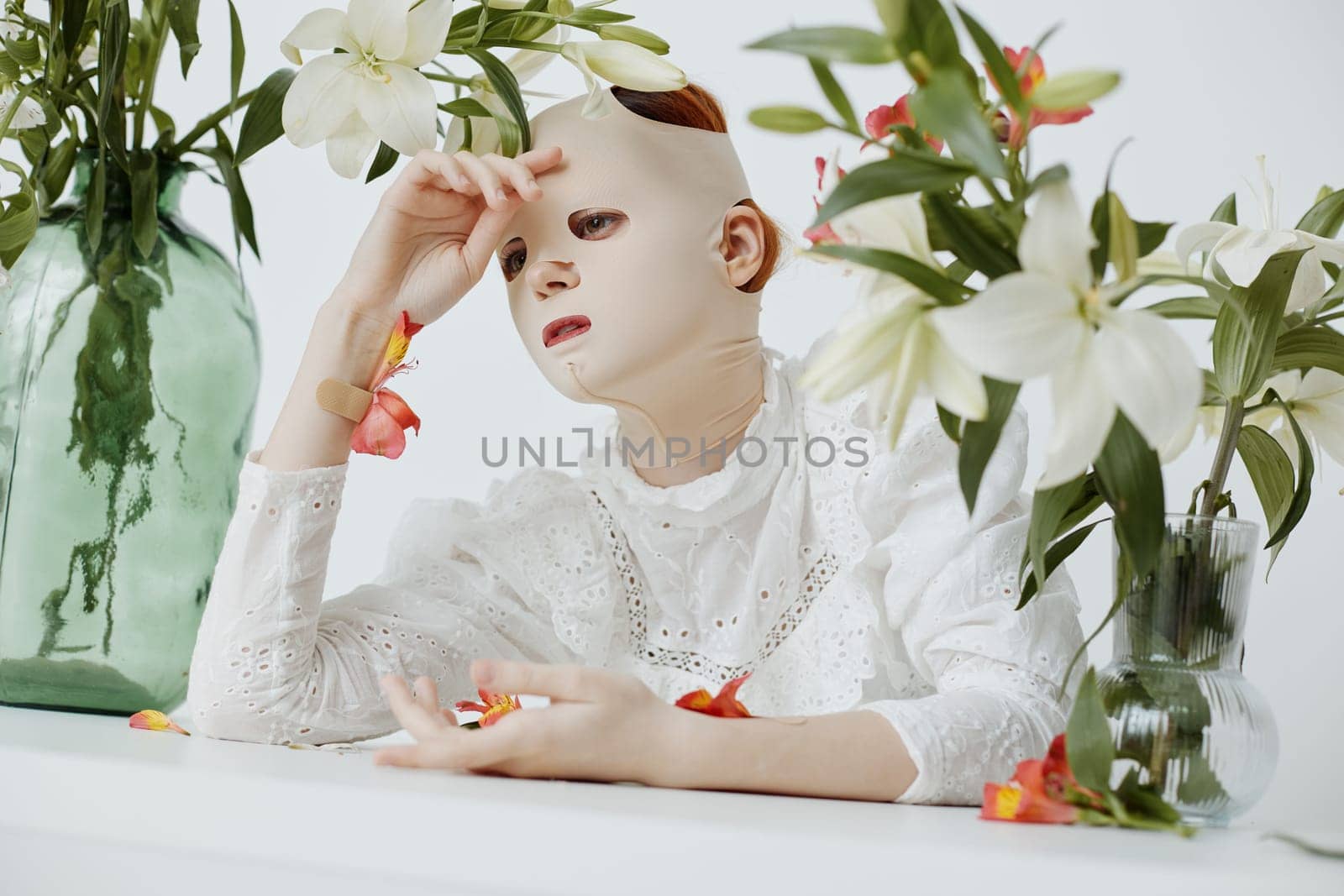 A serene scene featuring a contemplative model with a mask surrounded by white lilies, expressing beauty and vulnerability Perfect for themes of wellness and self care