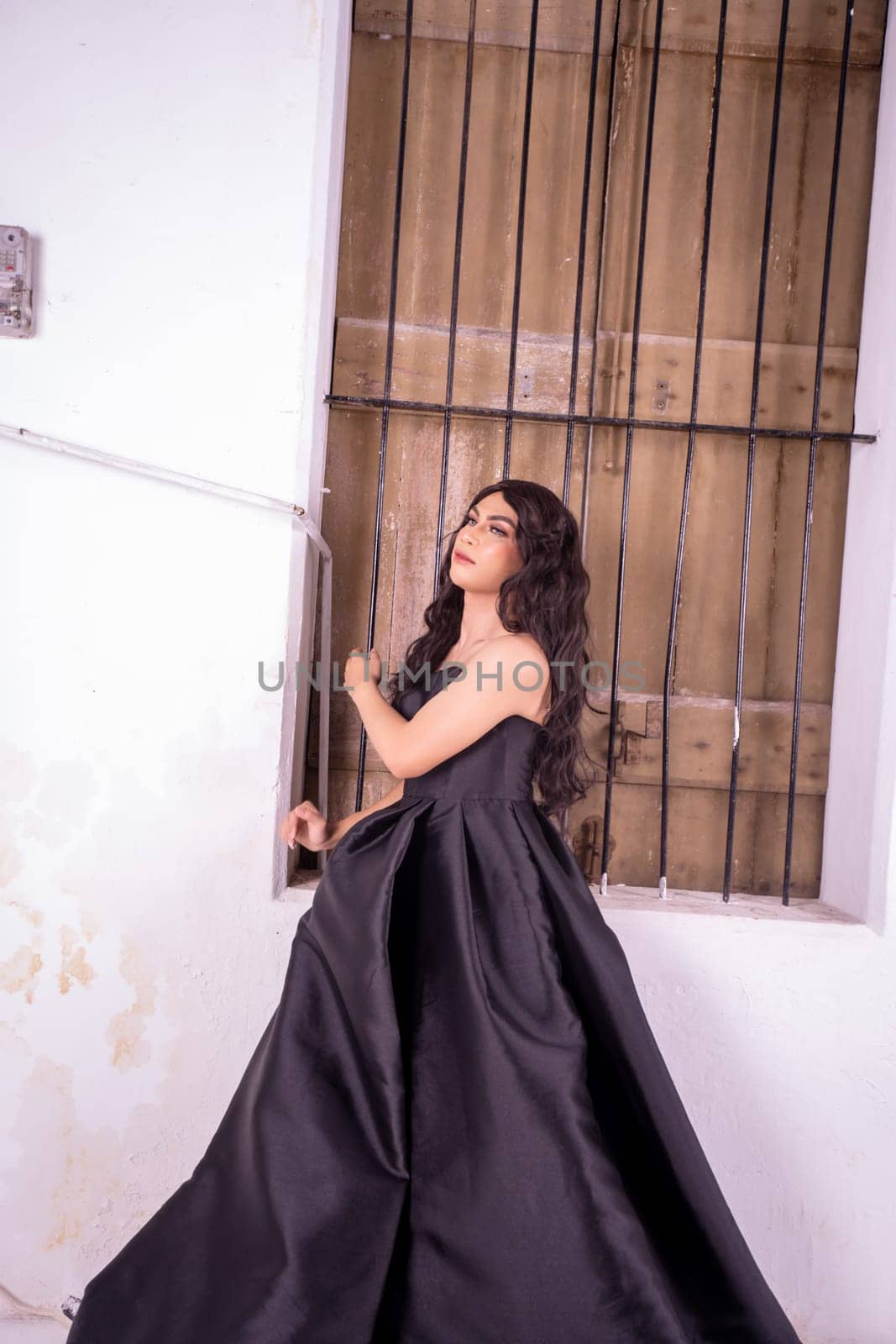Asian woman standing in the wooden window while wearing a black dress and black hair