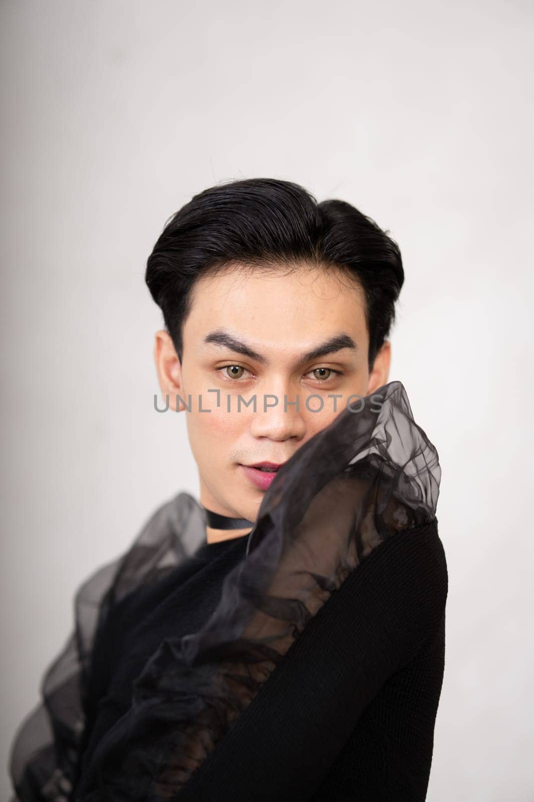 Beautiful Asian man wearing a black dance costume before the performance begins at the backstage