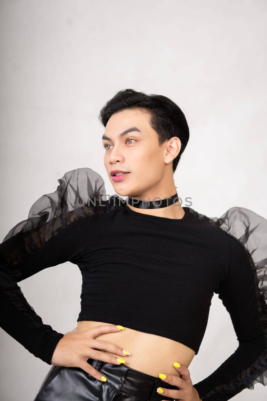 Beautiful Asian man wearing a black dance costume before the performance begins at the backstage