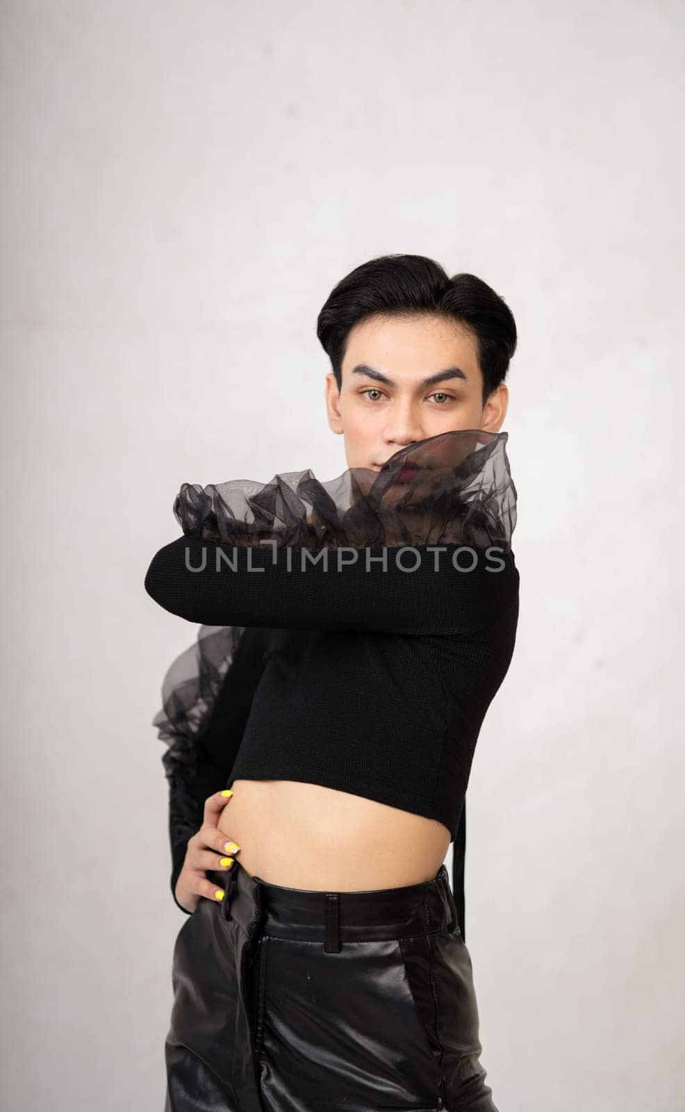 Beautiful Asian man wearing a black dance costume before the performance begins at the backstage