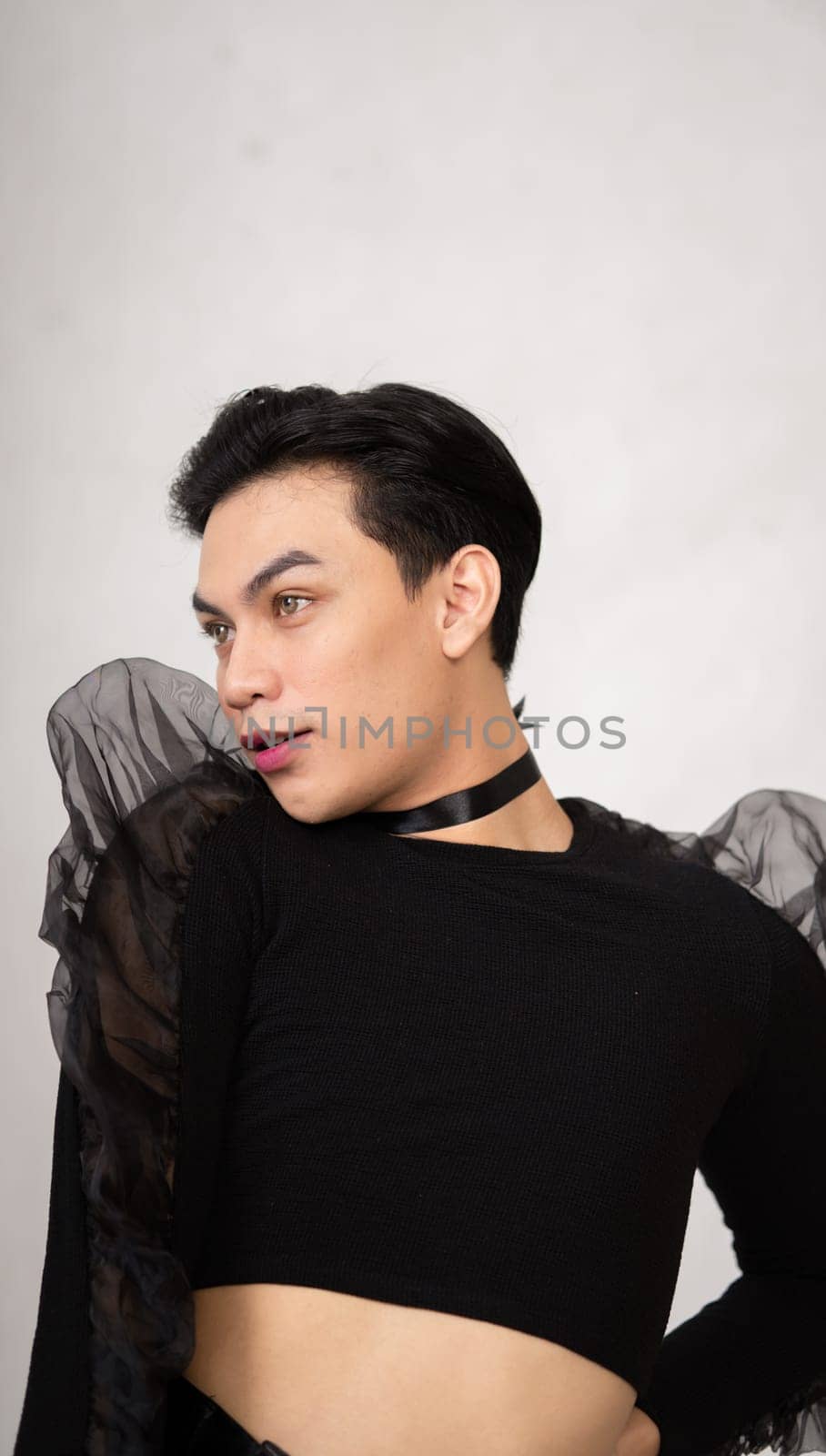 Beautiful Asian man wearing a black dance costume before the performance begins at the backstage