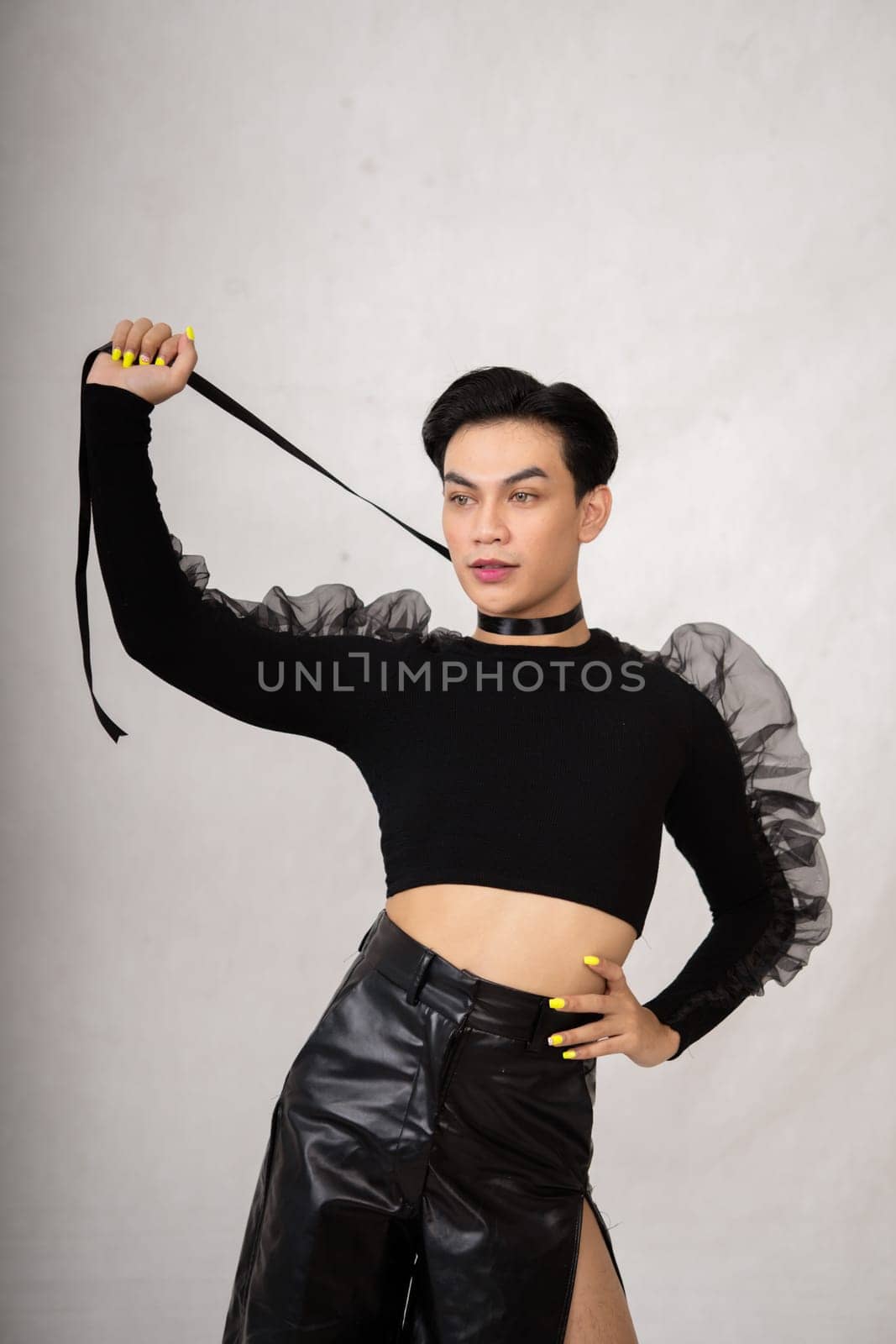 Beautiful Asian man wearing a black dance costume before the performance begins at the backstage