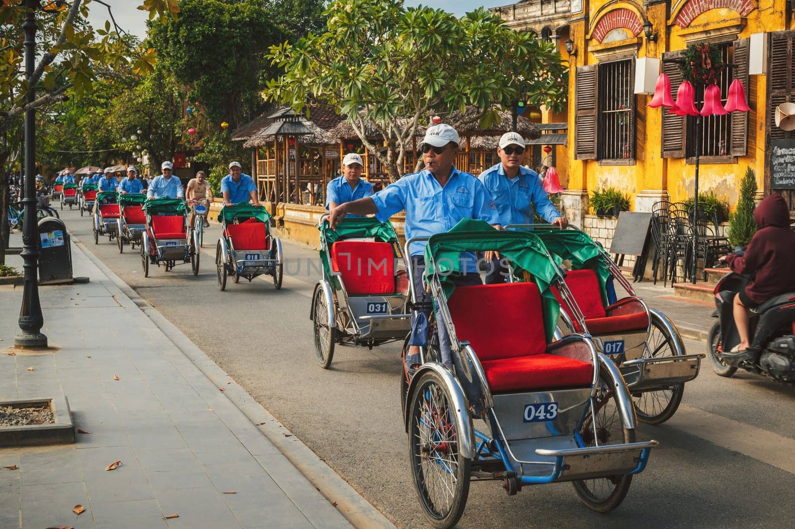 A traditional Asian transport is a bicycle rickshaw on the street of the old town in Hoi An city in Asia. Hoi An, Vietnam - December 1, 2024
